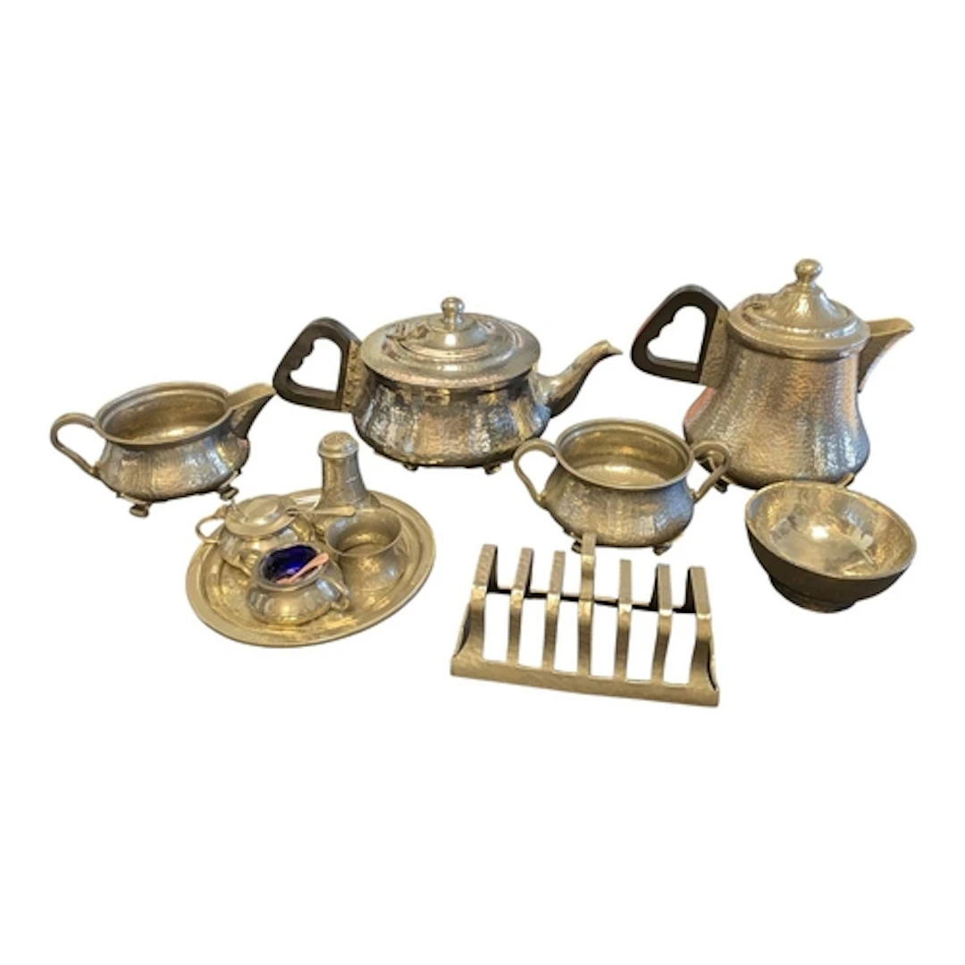 An Arts & Crafts planished pewter teapot and other items...