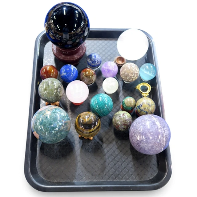 A group of specimen balls including amethyst, malecite, tige...