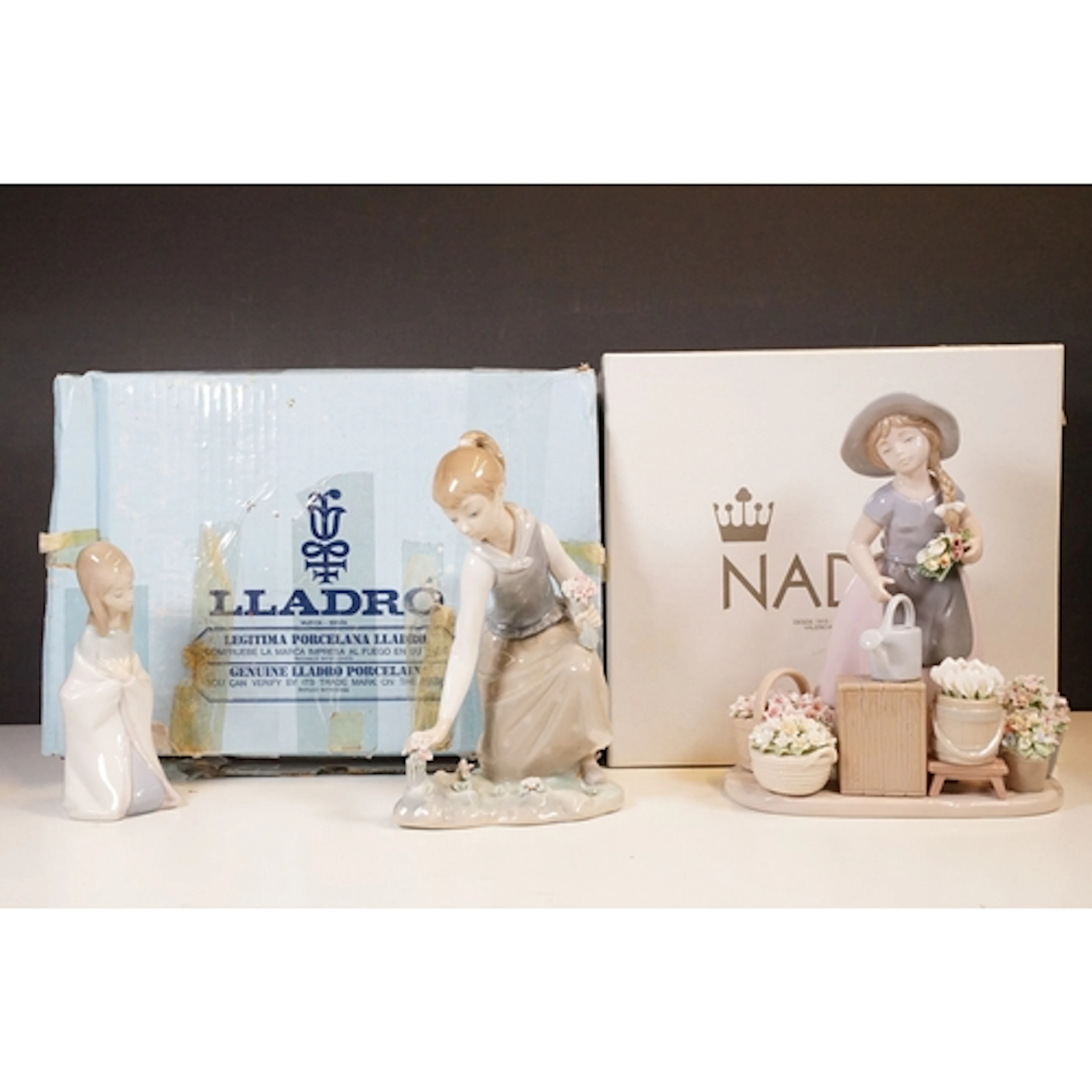 Two Lladro figurines to include 'Girl gathering flowers' and...