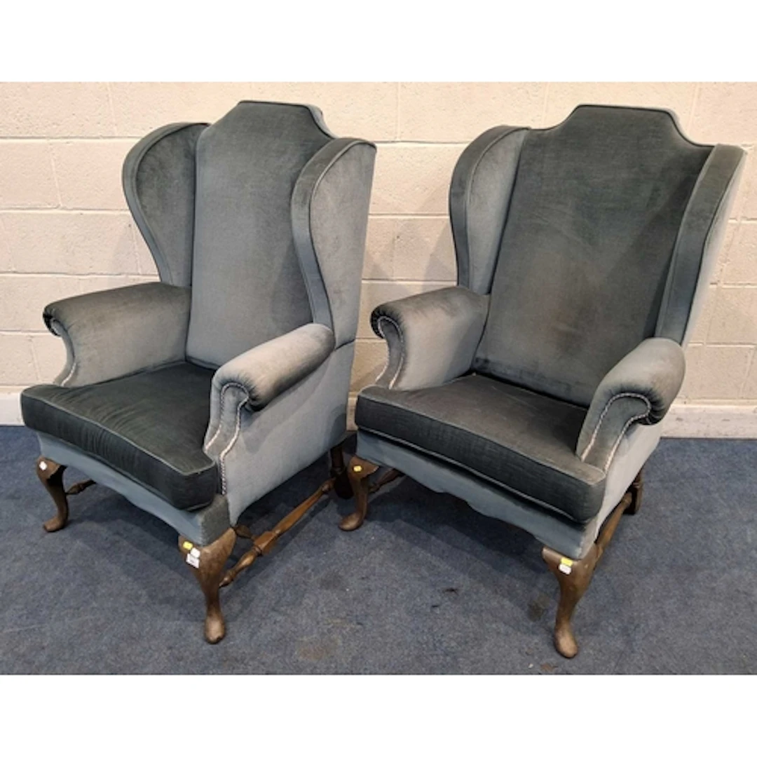 A PAIR OF GEORGIAN STYLE WING BACK ARMCHAIRS, with light blu...