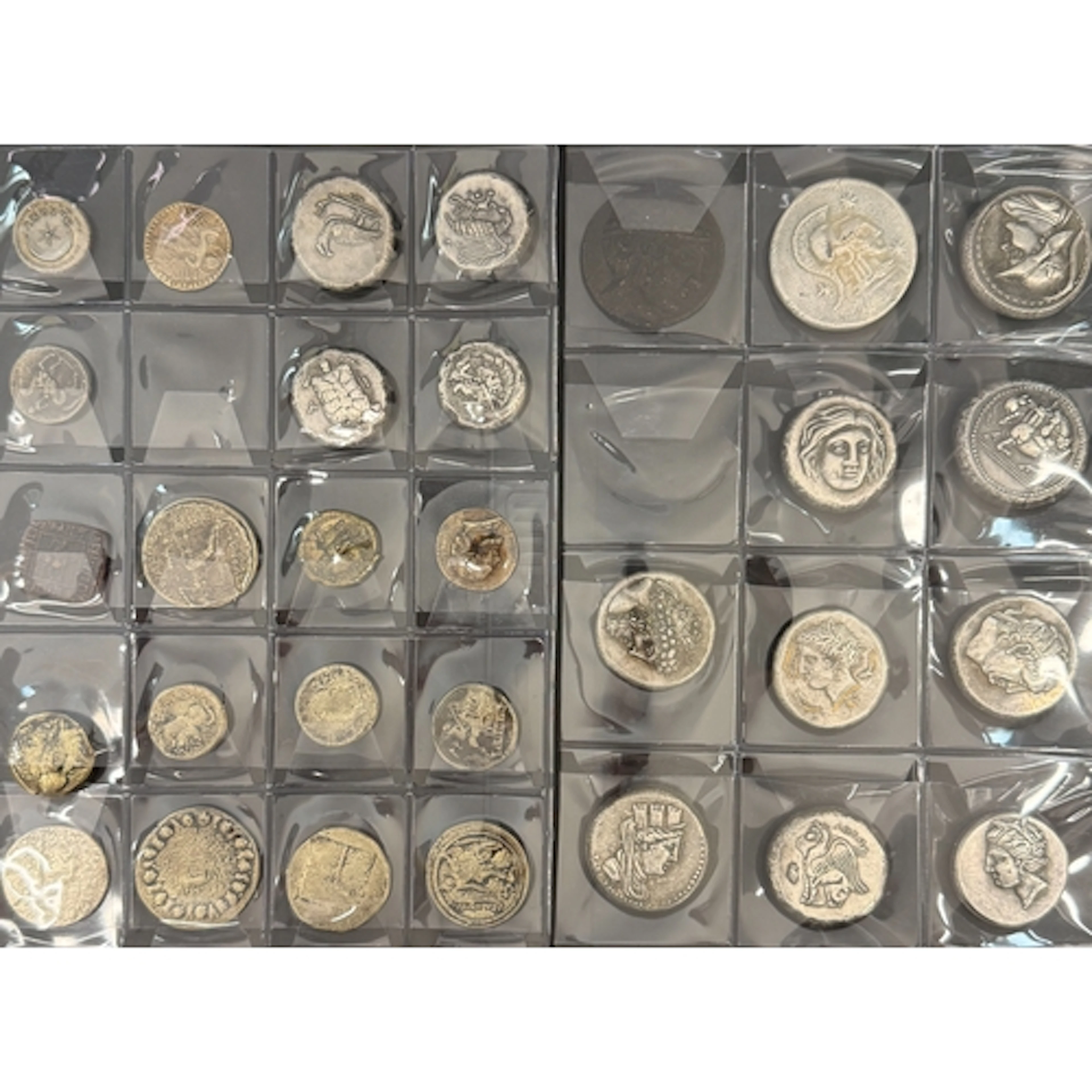 A collection of 65 Ancient Greek silver and bronze coin forg...