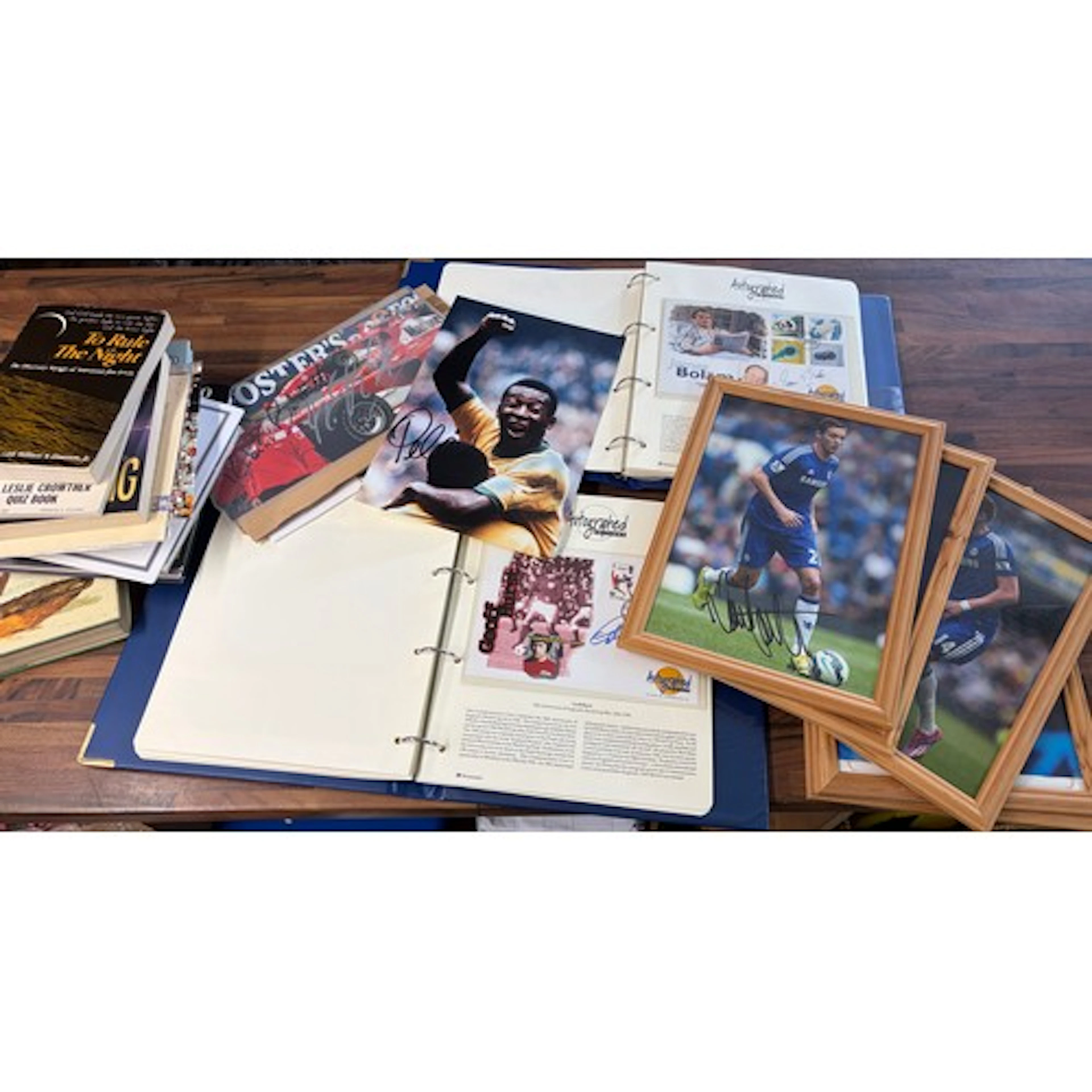 a collection of various autographed items including books, p...