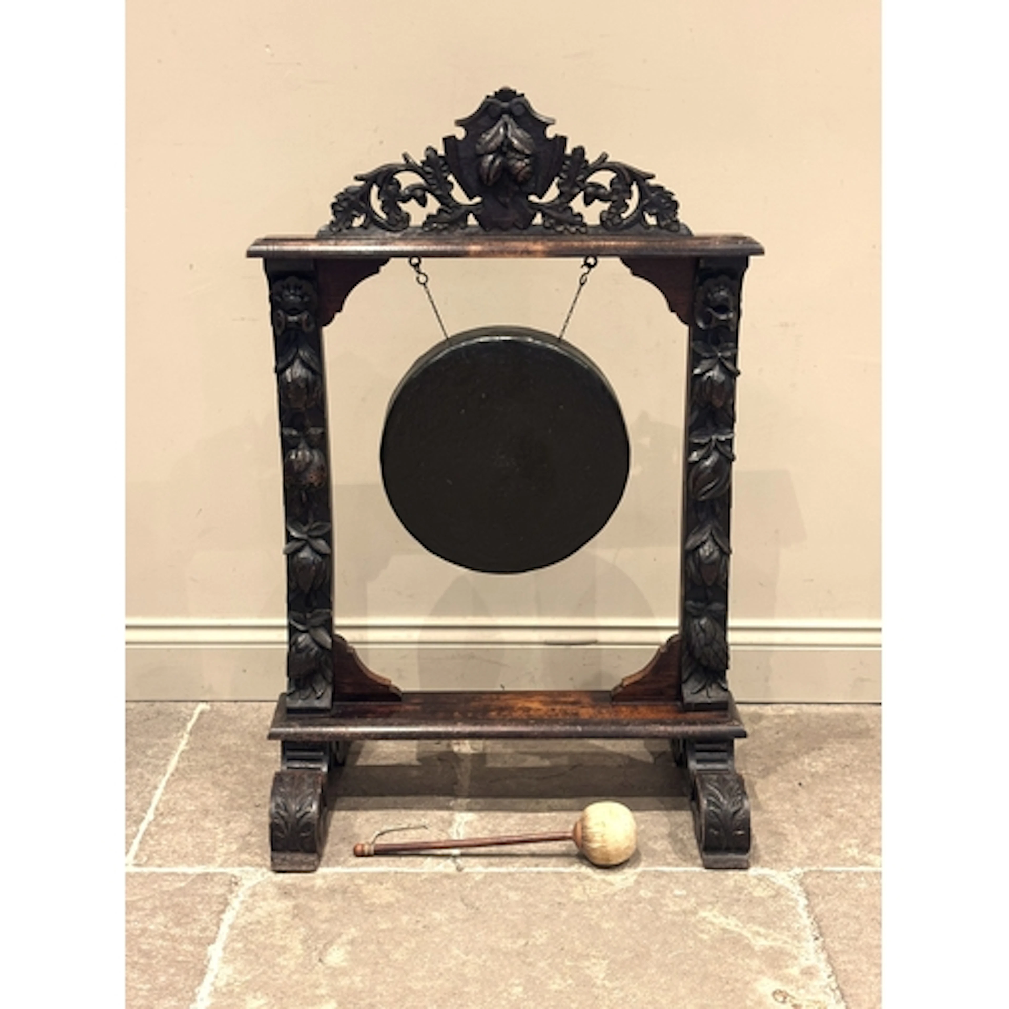 A floor standing Victorian carved oak and bronze dinner gong...