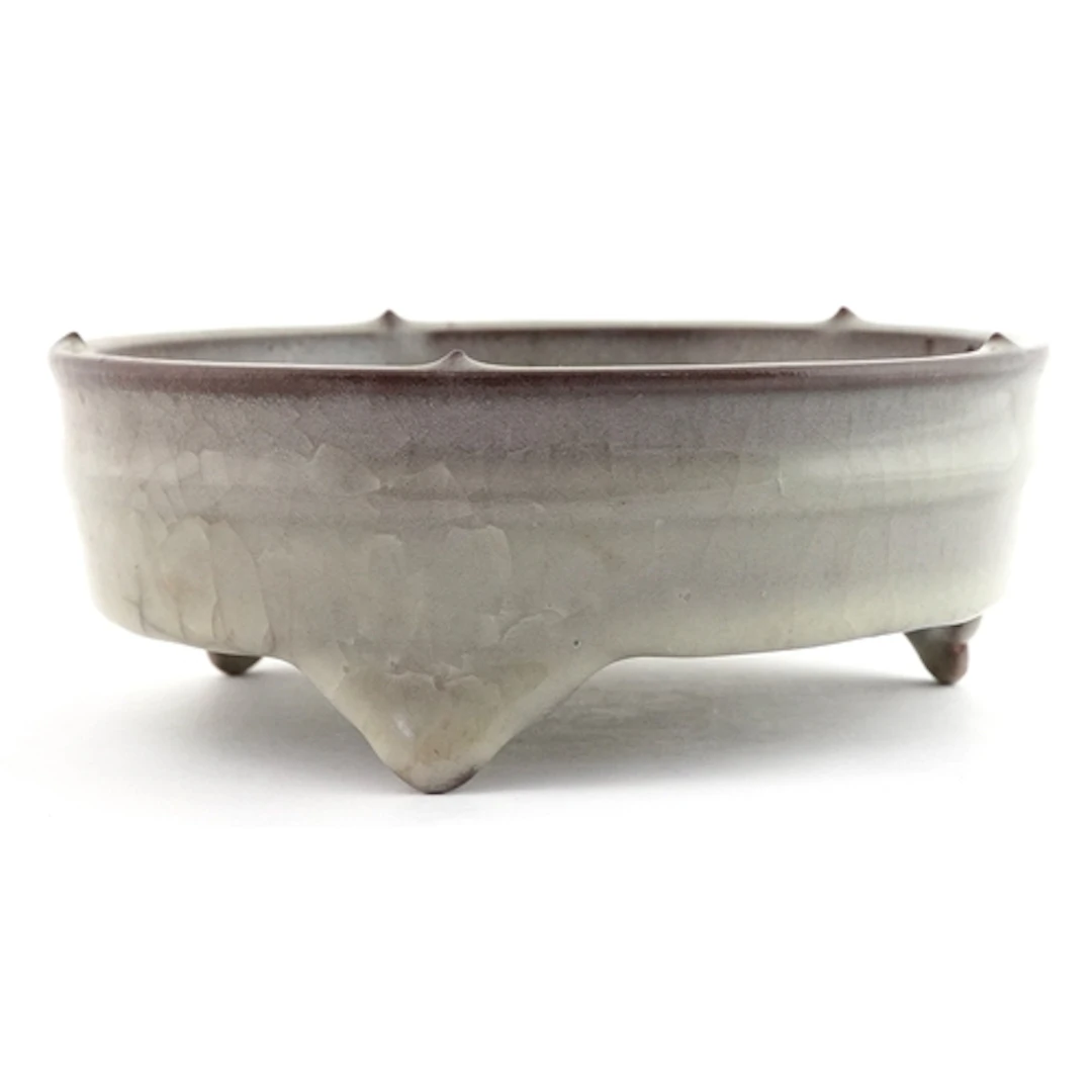 Chinese grey glazed celadon tripod censer, 17cm wide.