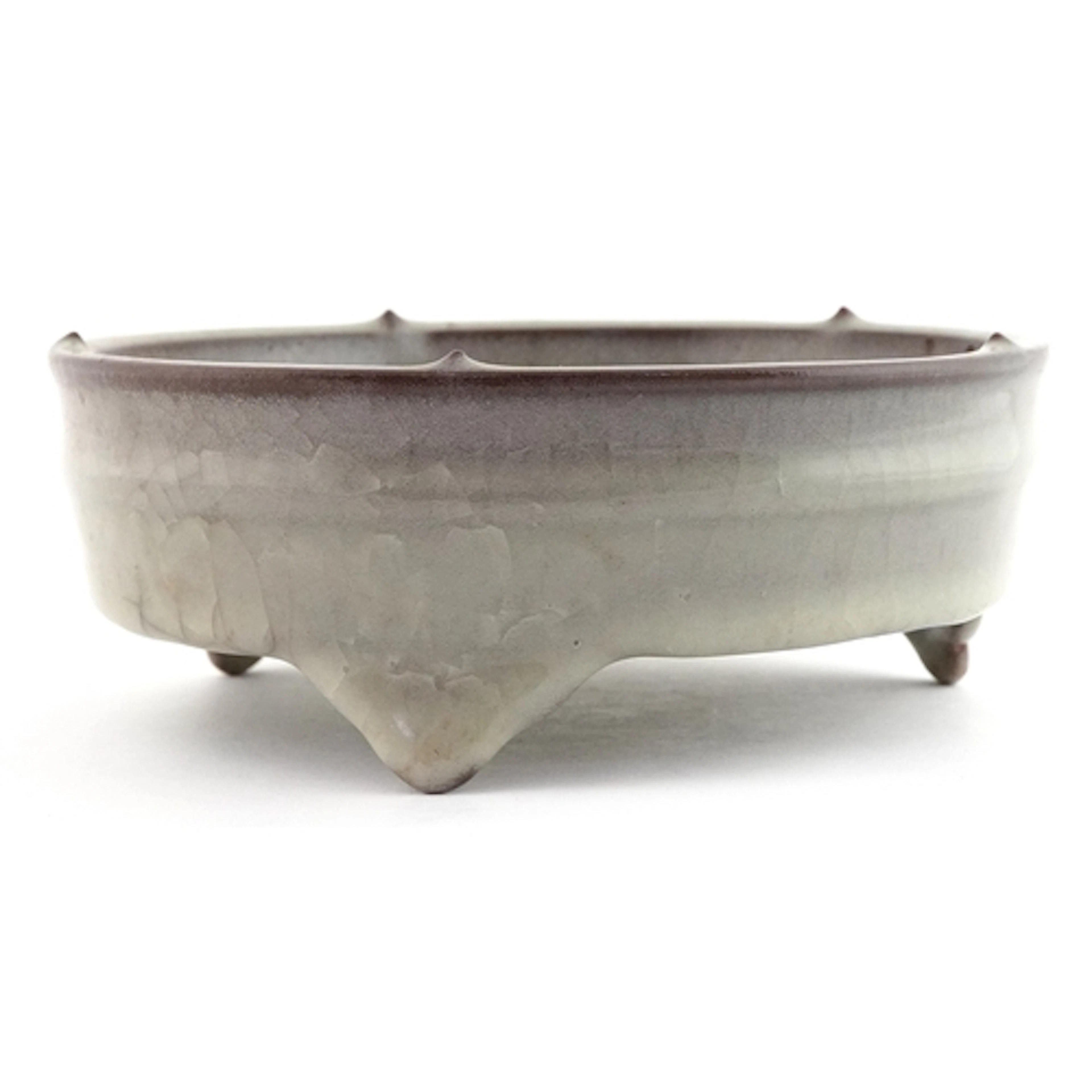 Chinese grey glazed celadon tripod censer, 17cm wide.
