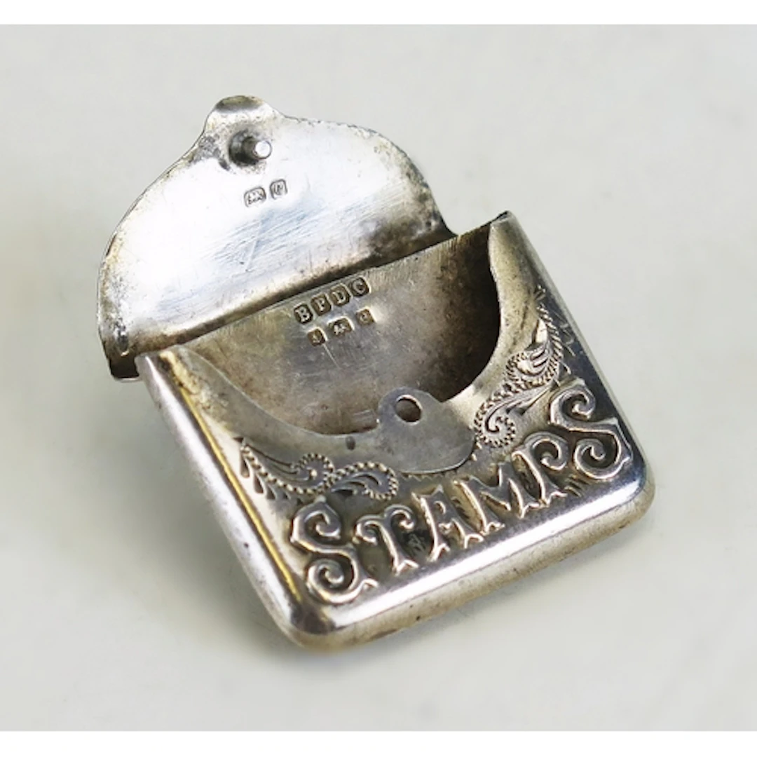 An Edward VII silver stamp holder, maker Boots Pure Drug Com...