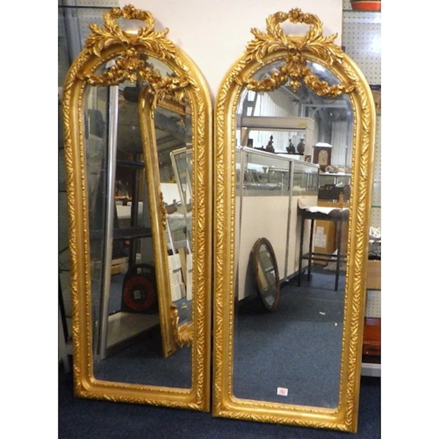 A pair of Neo-Classical style gilt framed mirrors of slender...