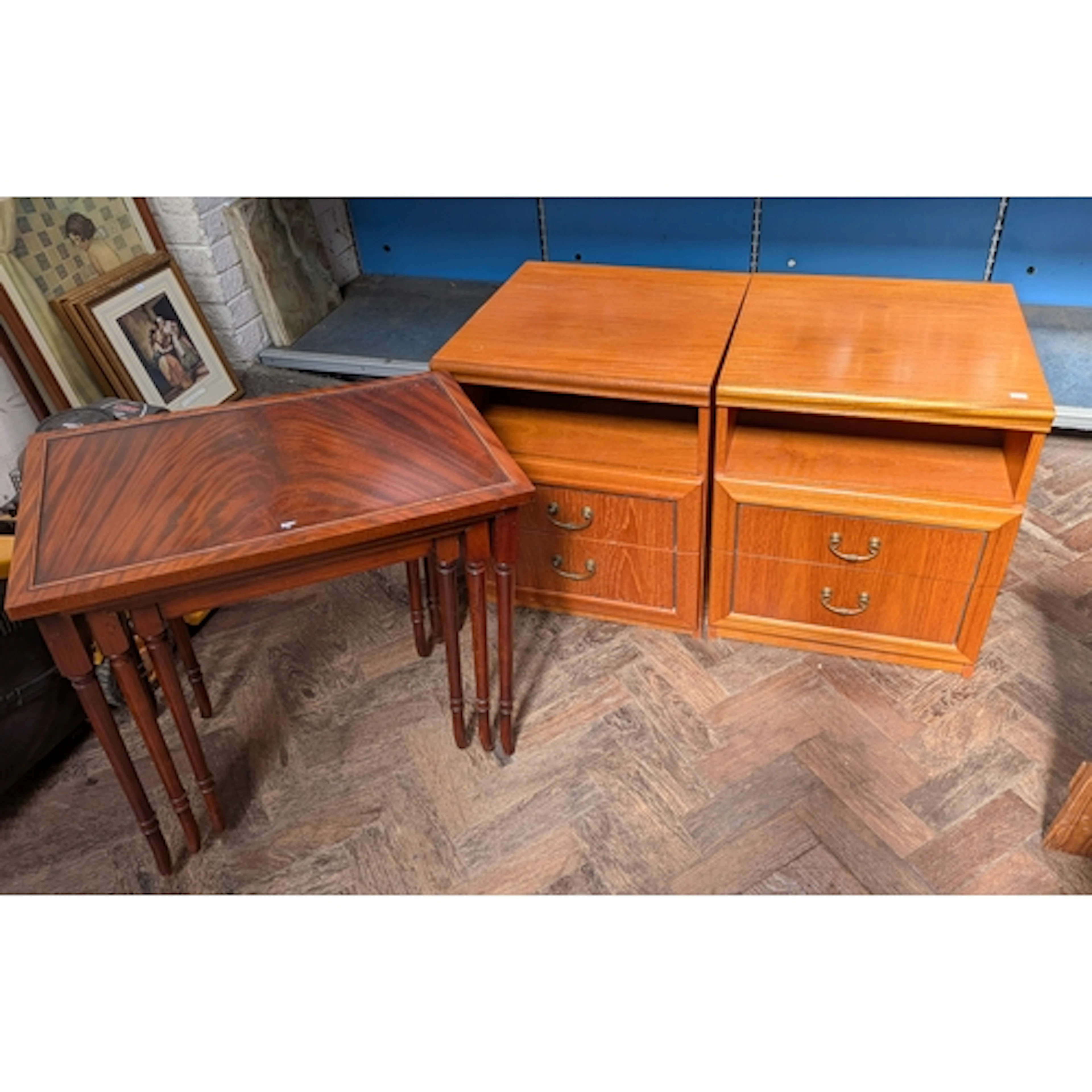 A pair of teak two drawer bedside chests or lamp tables toge...