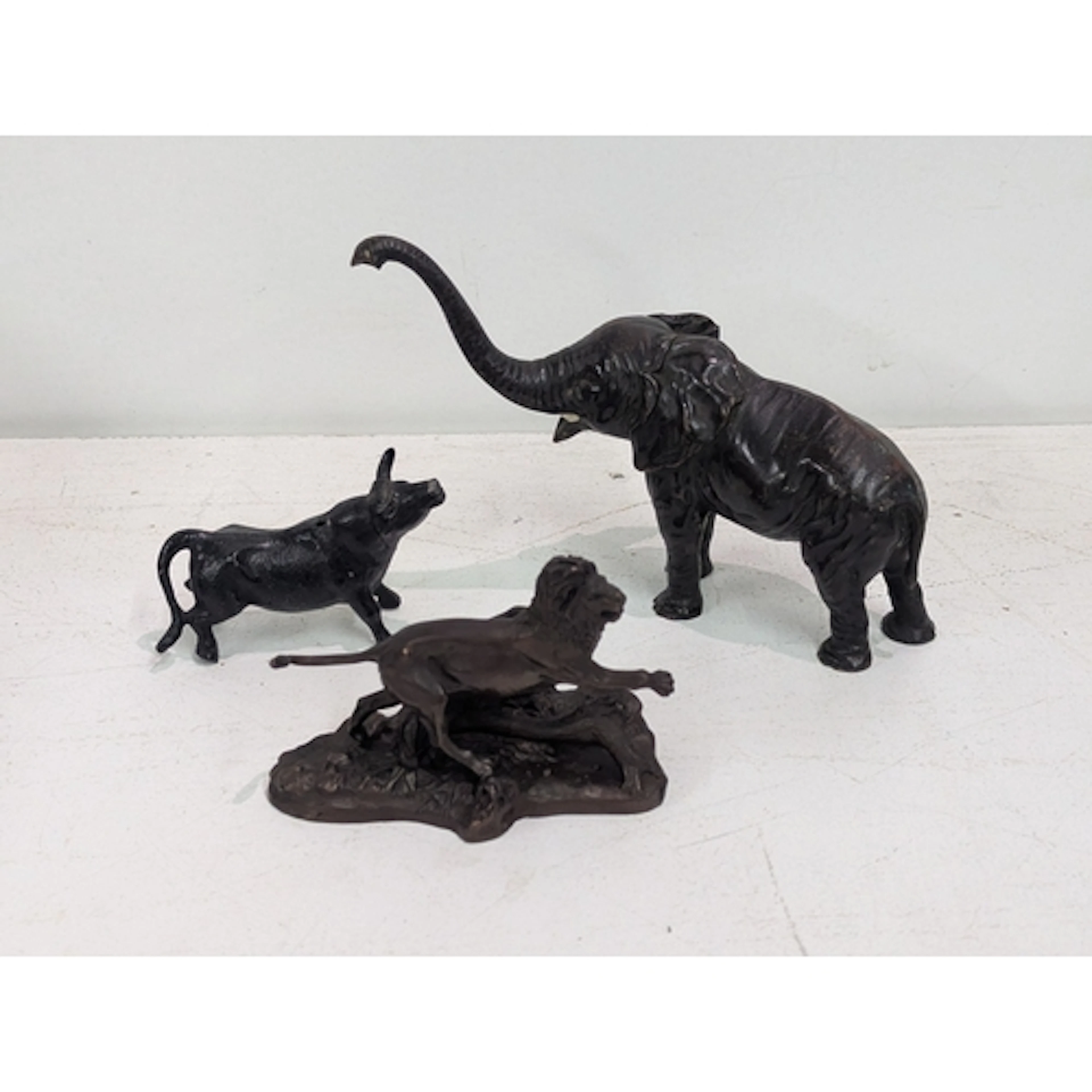 Three animal sculptures to include a bronze example of a lio...