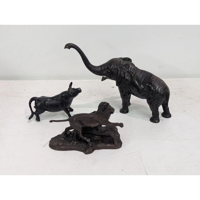 Three animal sculptures to include a bronze example of a lio...