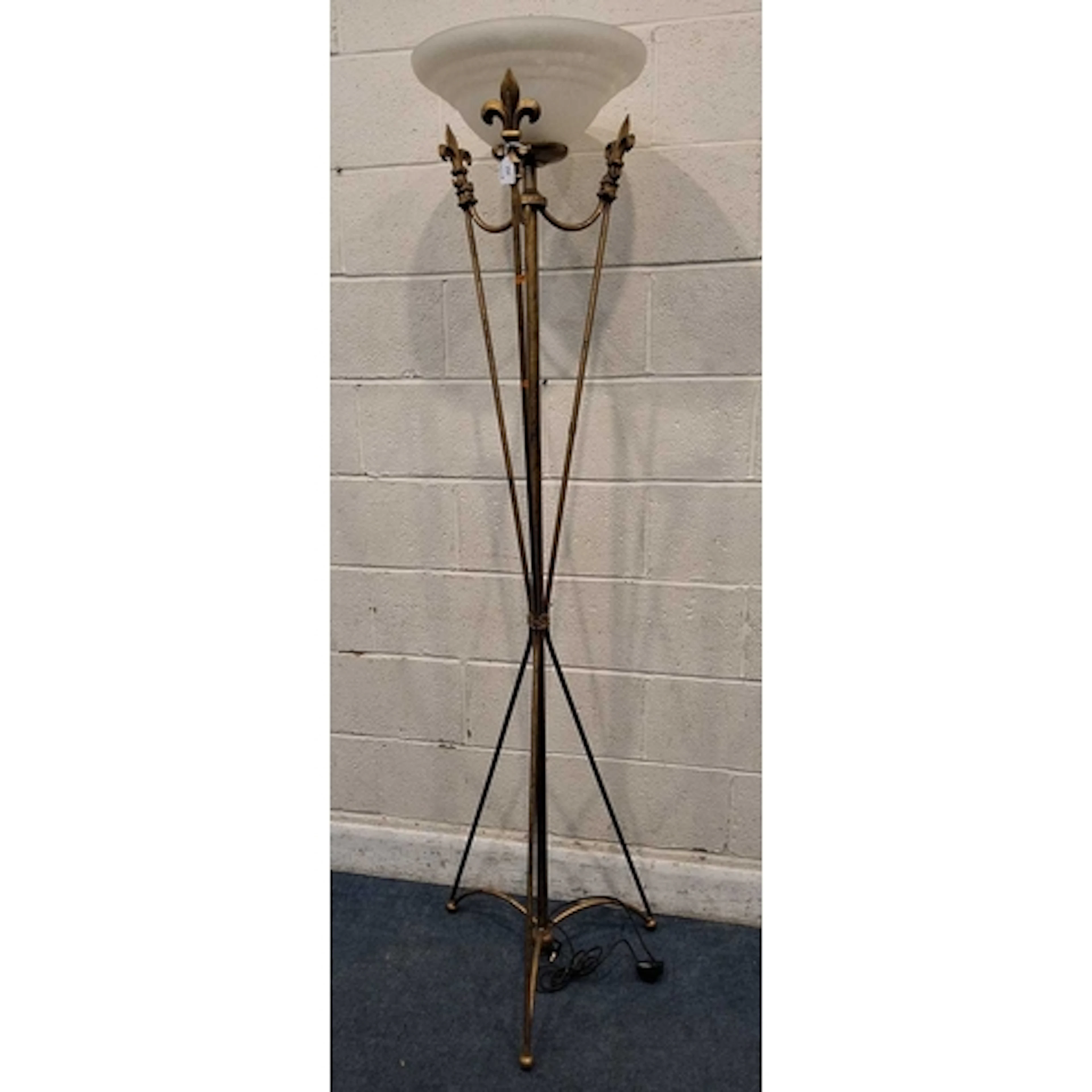 A GILT METAL STANDARD LAMP, with a frosted glass shade, rais...