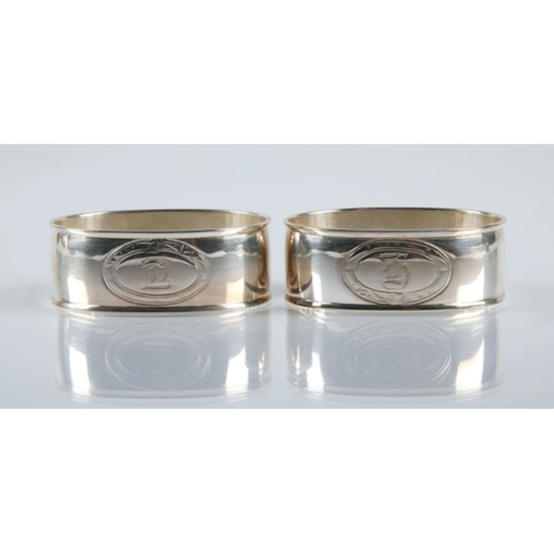 Pair of silver monogrammed napkin rings, gross weight 48.2g.