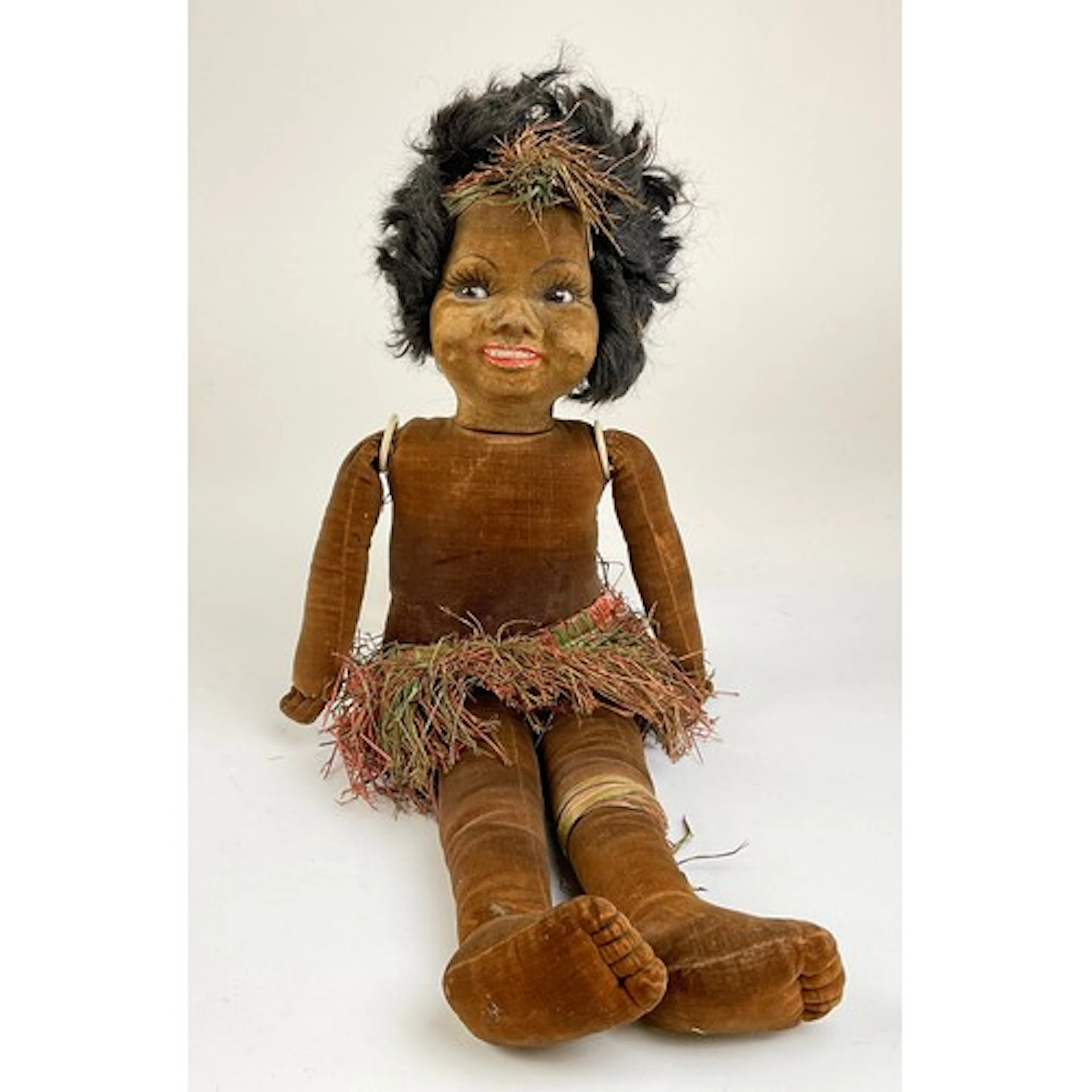 A Norah Wellings South Sea Islander black doll, brown glass ...