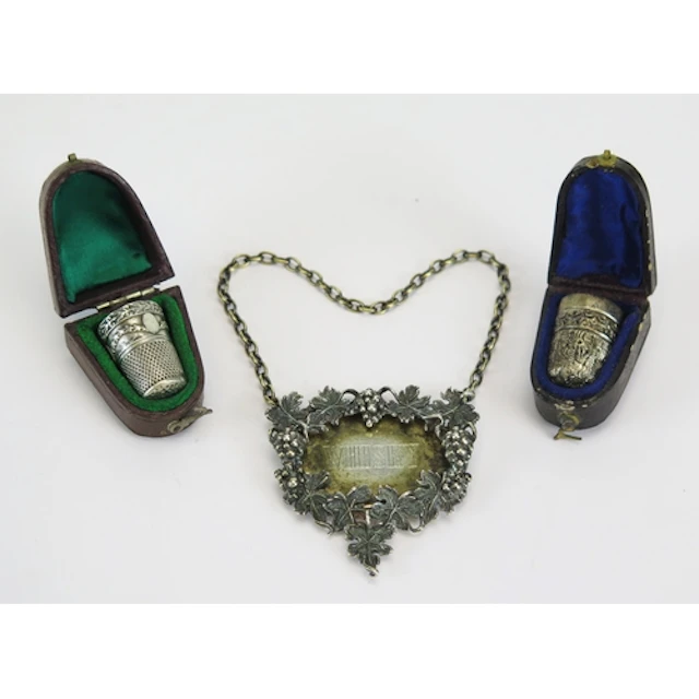 A silver thimble, cased, together with a silver whisky decan...