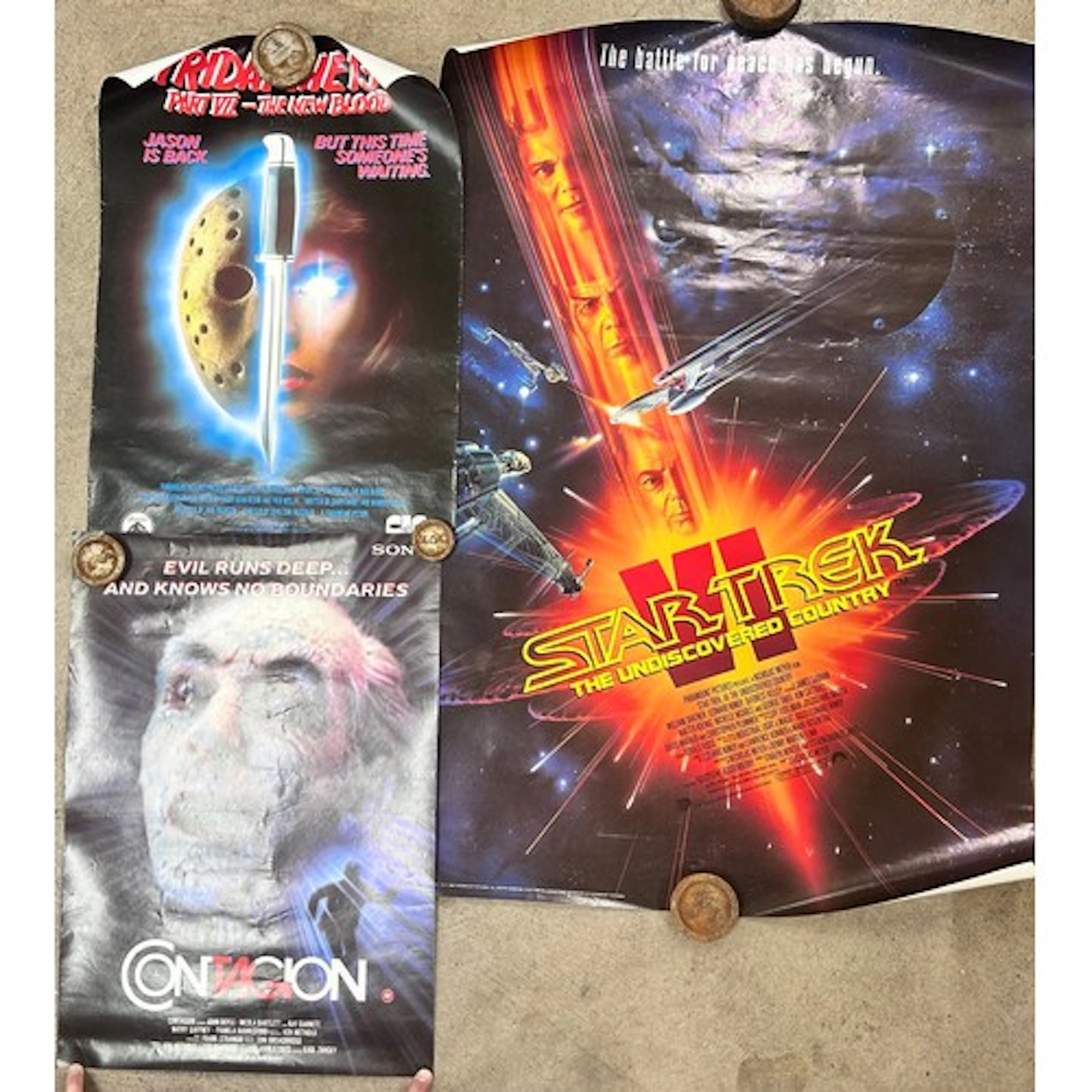 A collection of movie posters consisting of 1992 Star Trek, ...