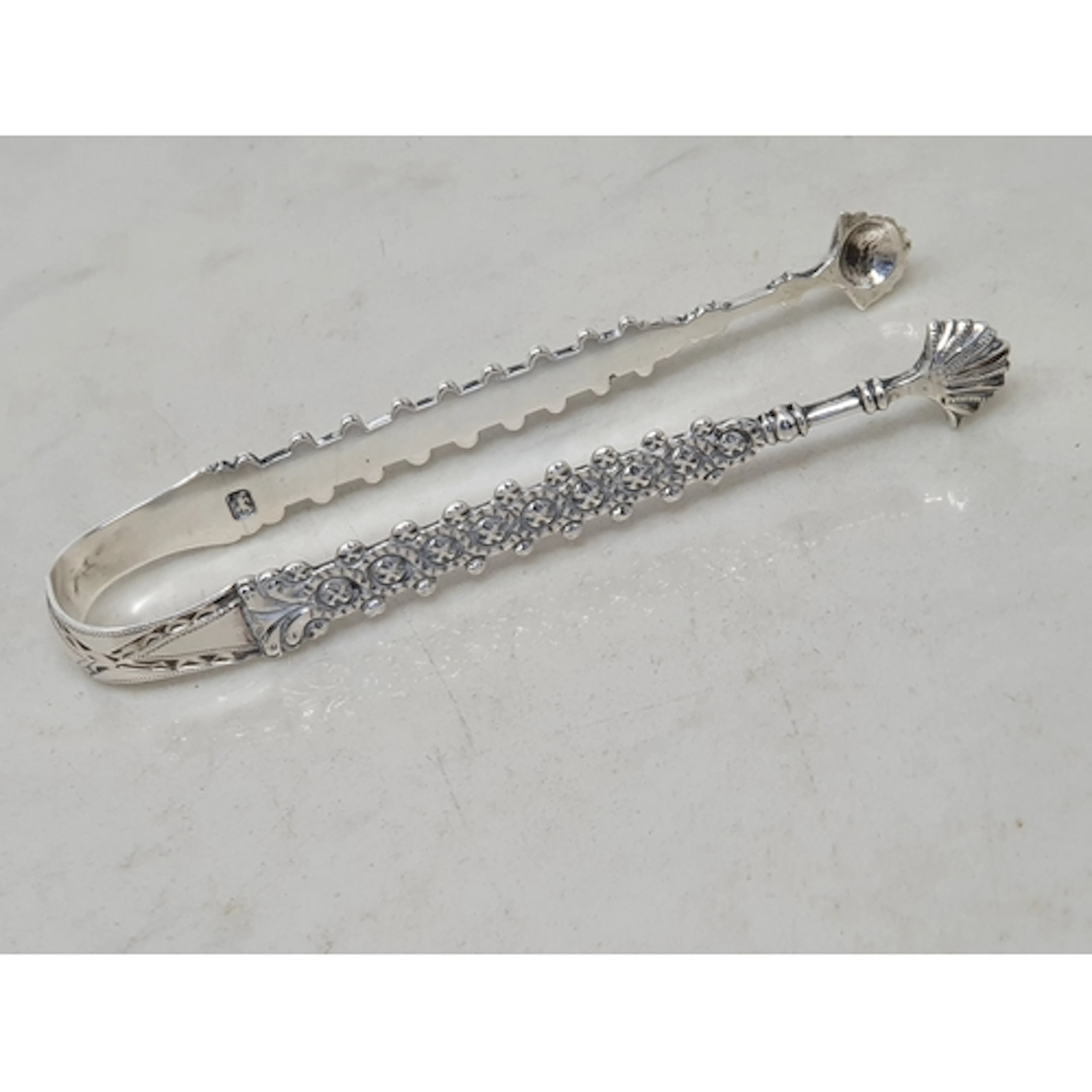 A pair of Georgian Chippendale design Sugar Tongs with brigh...
