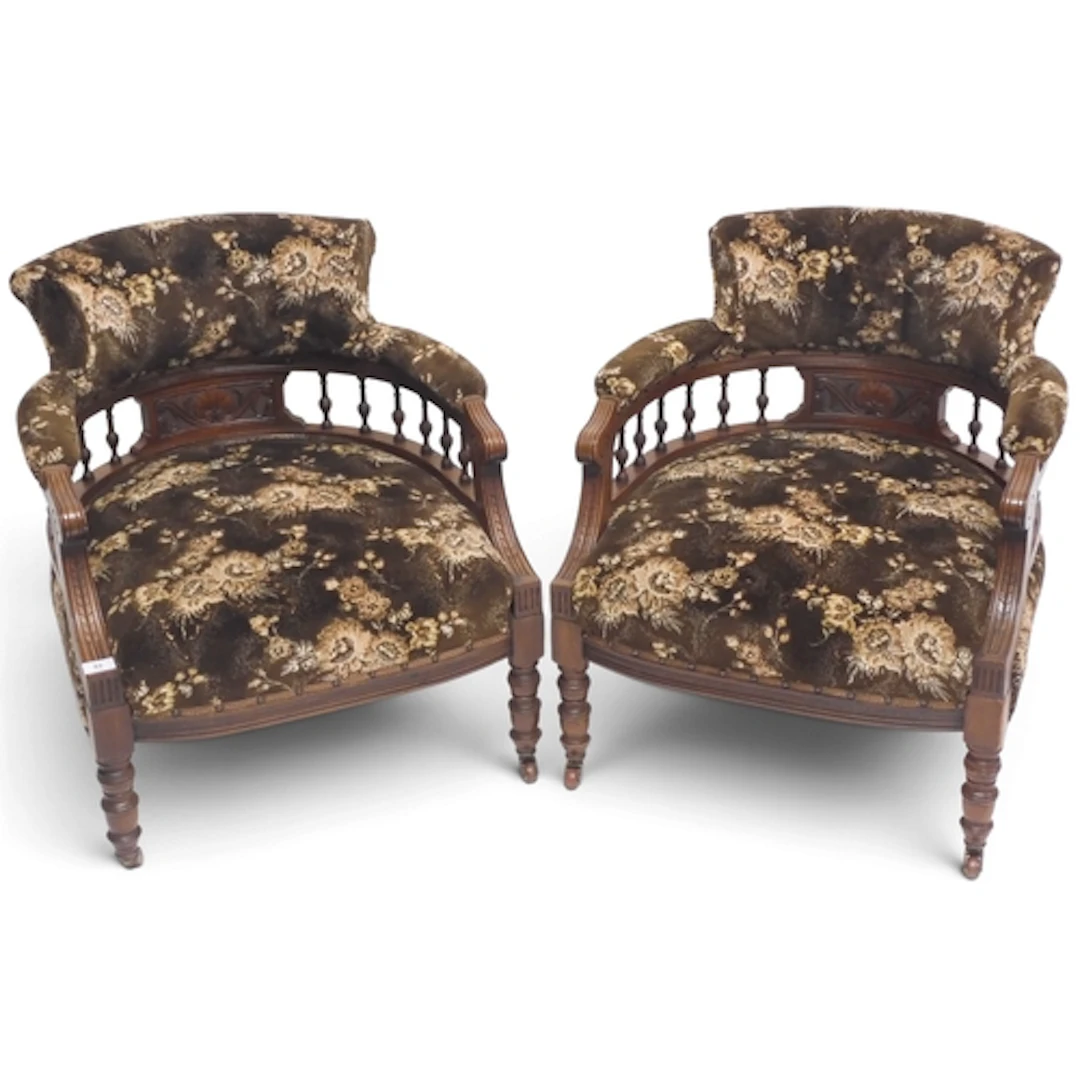 A pair of late Victorian walnut framed tub armchairs with sp...
