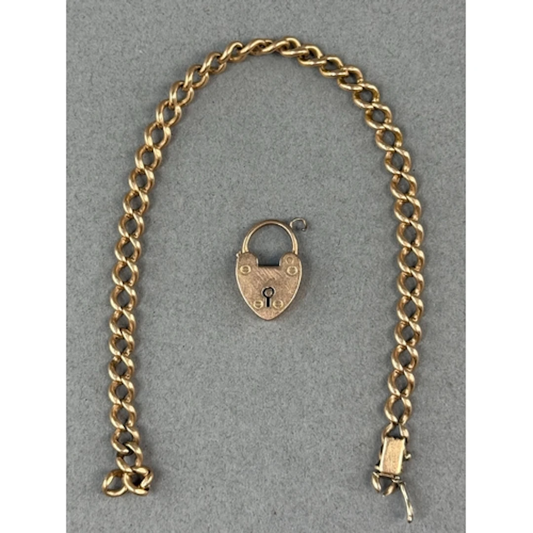 Jewellery: a yellow metal curb link bracelet, broken, testin...