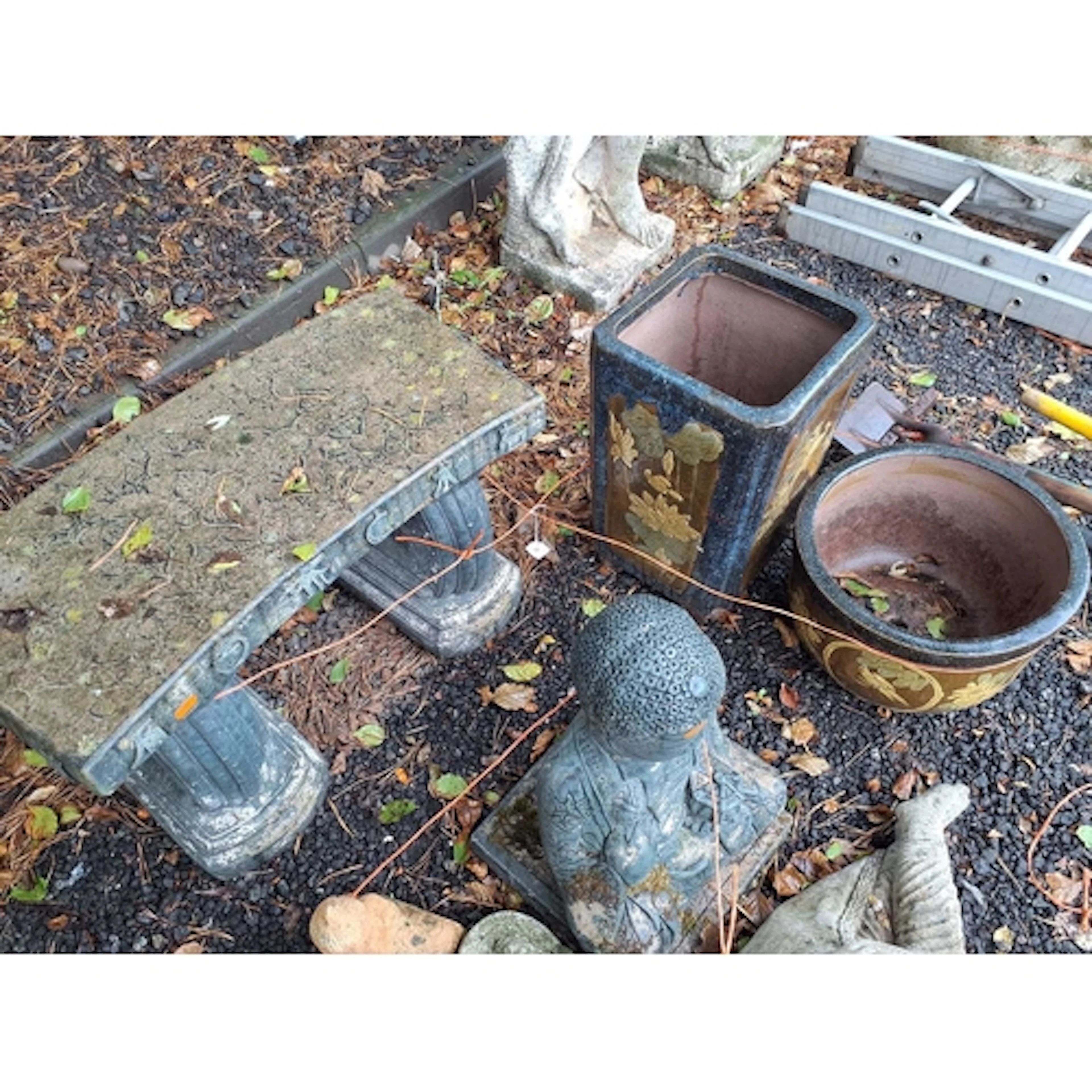 A CONCRETE GARDEN BENCH WITH ORIENTAL CHARACTERS ON TOP, 67c...