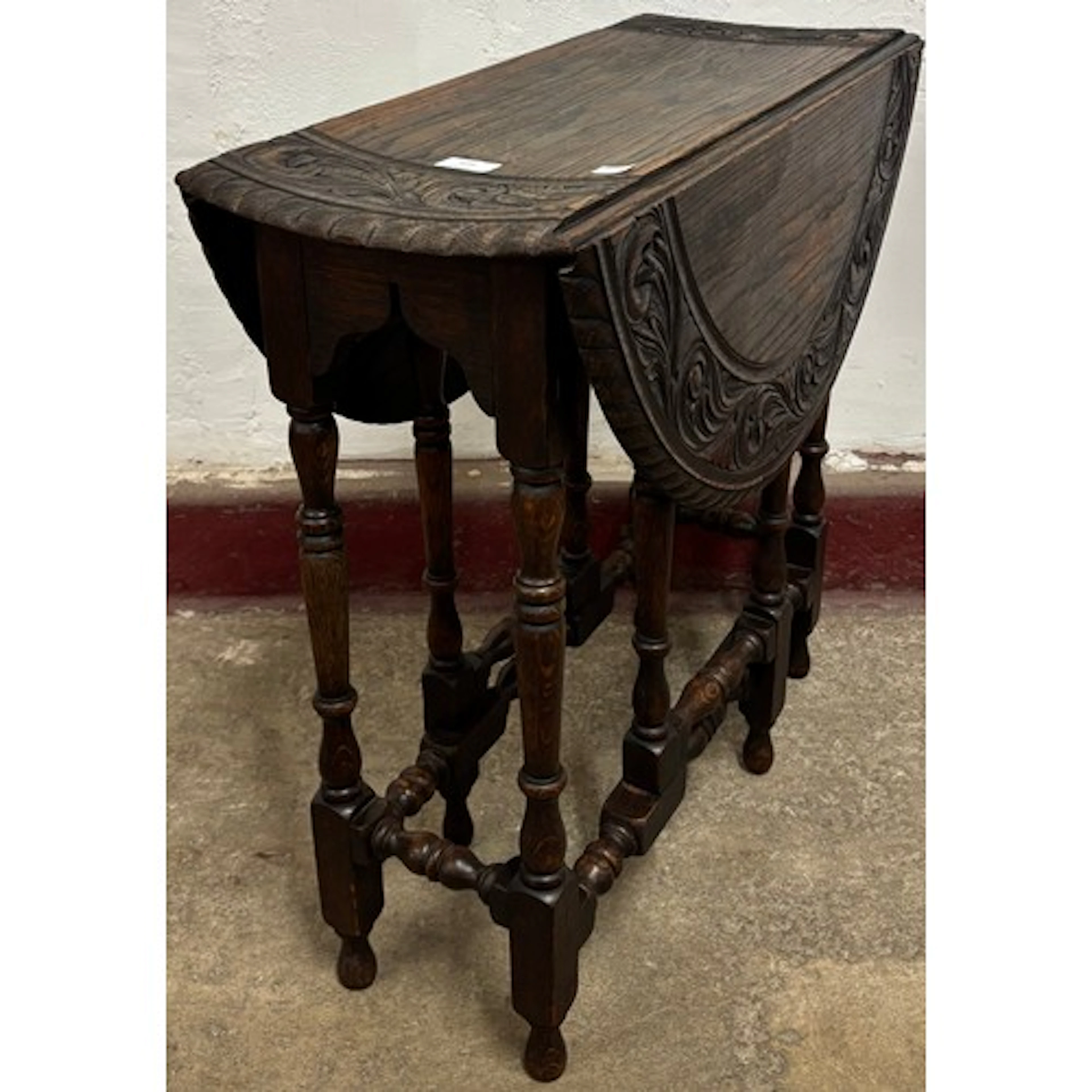 A late Victorian carved oak gateleg table