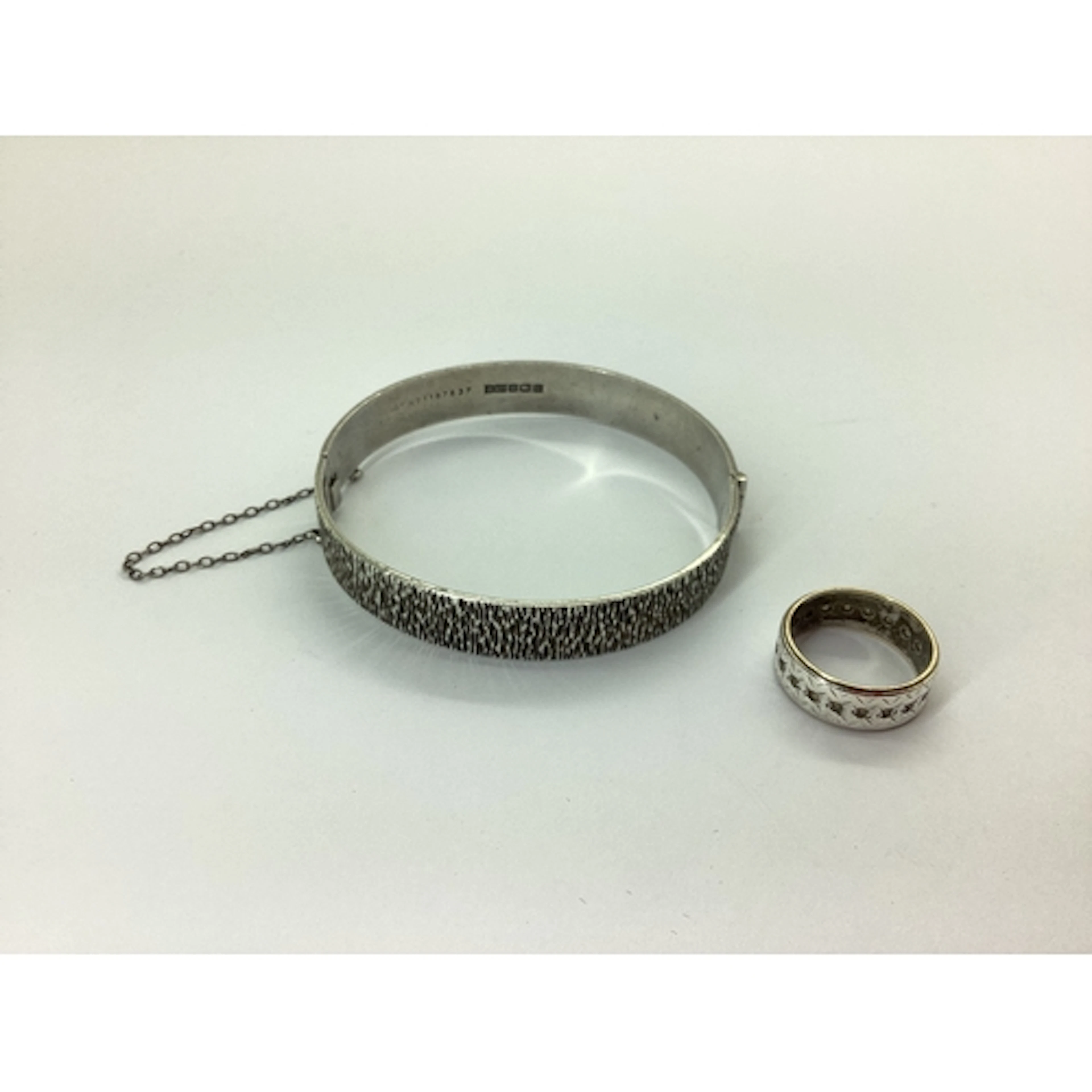 A Hallmarked Silver Hinged Bangle, allover textured finish, ...