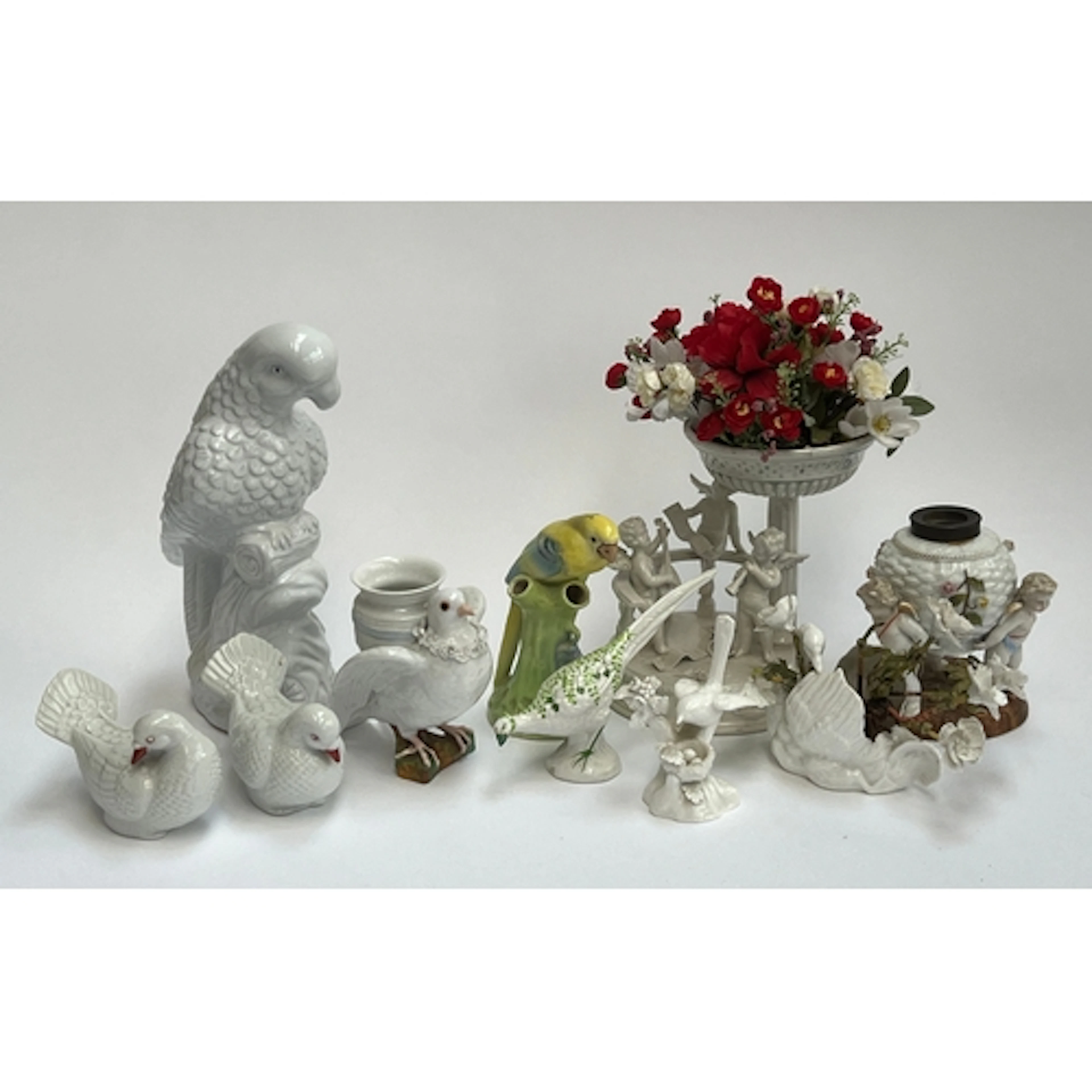 An Italian white porcelain centrepiece with cherubs; a baske...