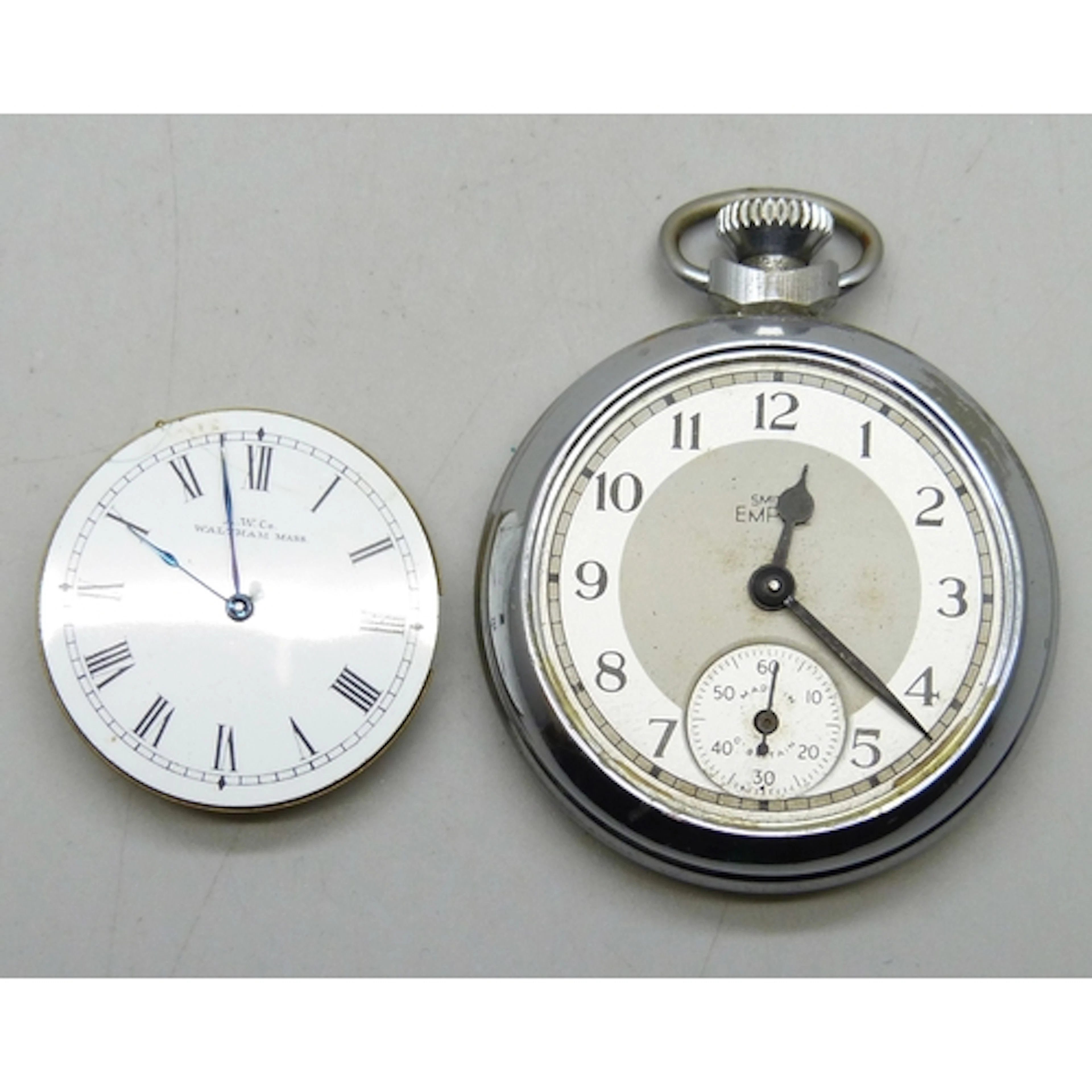 A Smiths Empire pocket watch, lacking glass, and a Waltham w...