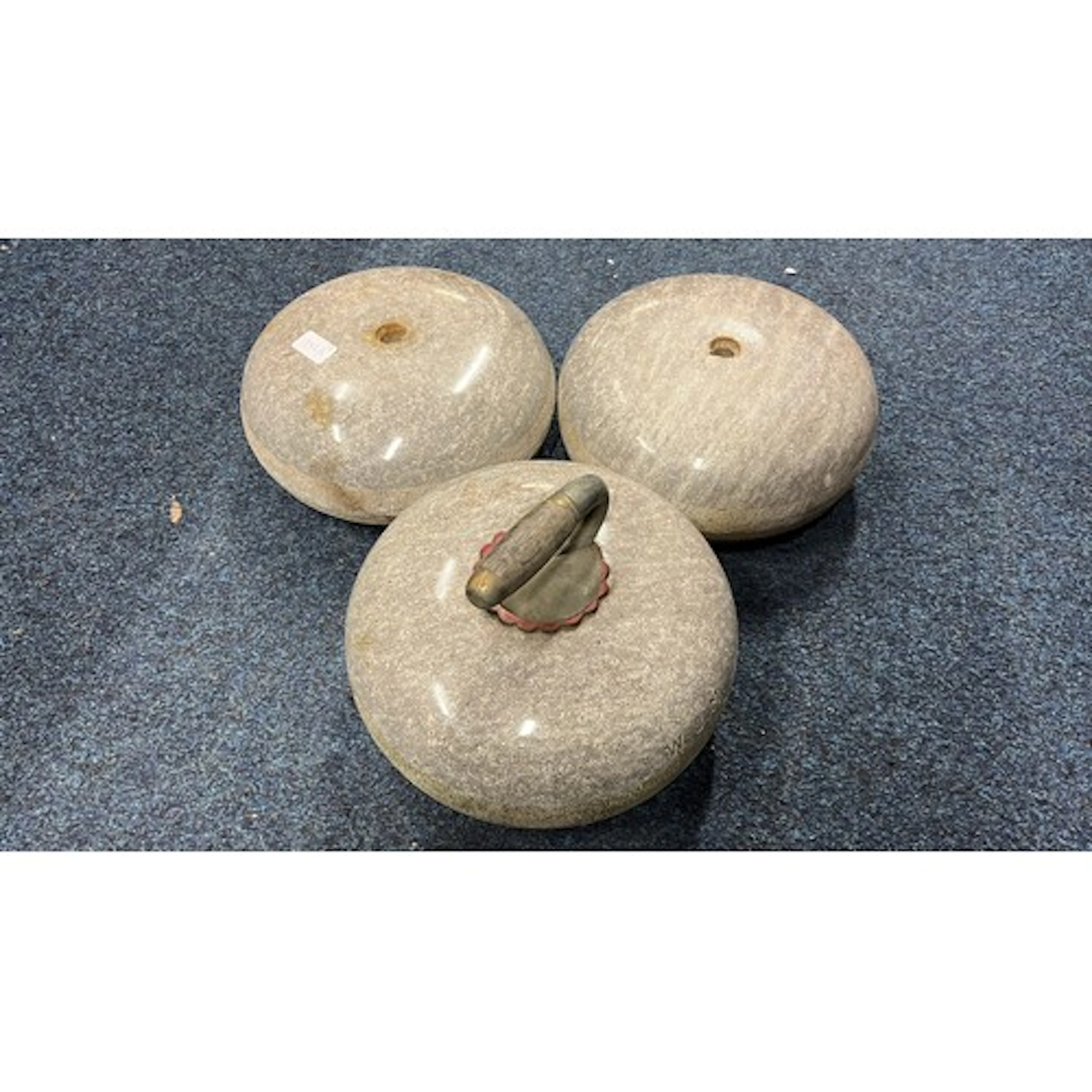 Group of three curling stones.