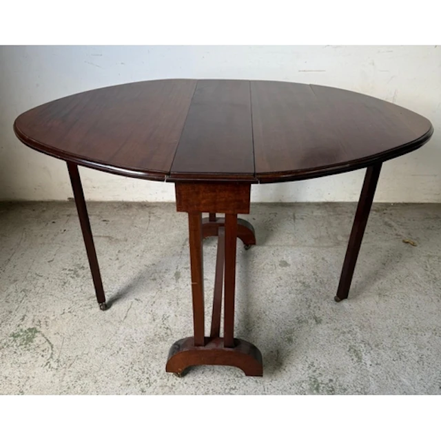 A Mahogany drop leaf lozenge shaped table with cross stretch...