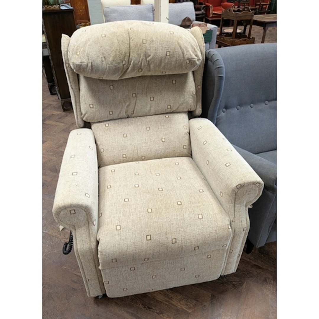 An electric rise and recline easy chair in beige mottled cov...