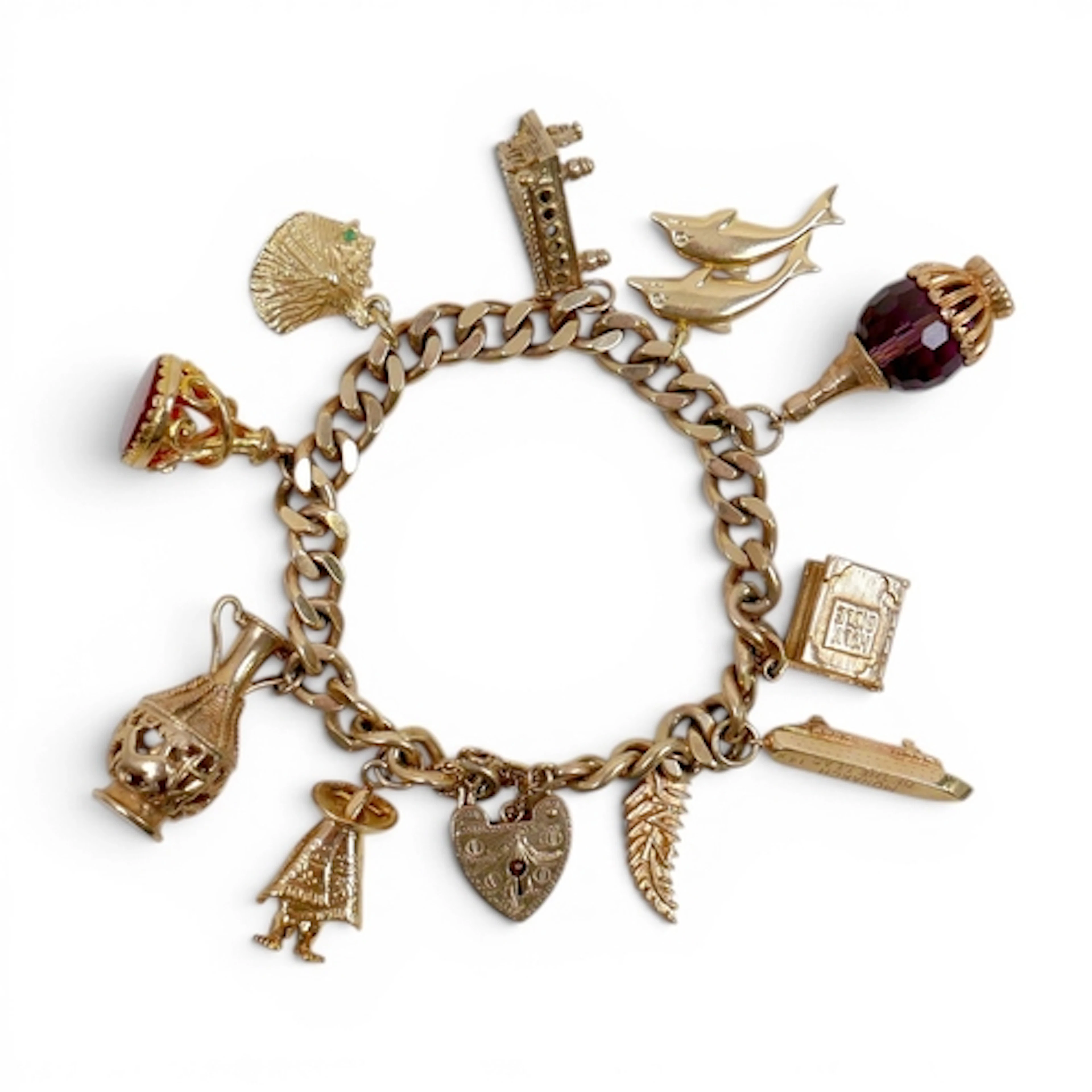 A 9CT GOLD CHARM BRACELET, FLAT CURB, WITH ASSORTED 9CT AND ...