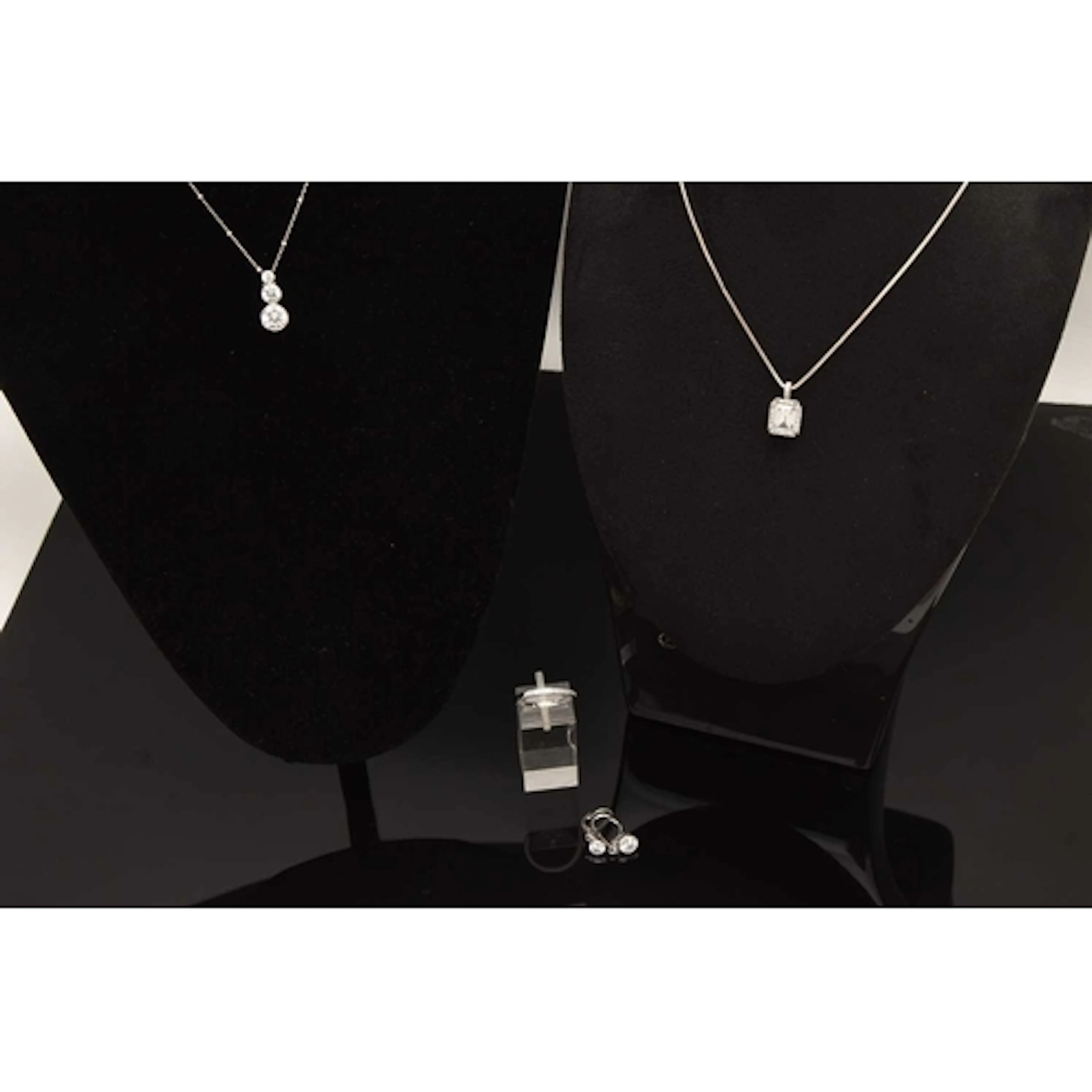 AN ASSORTMENT OF JEWELLERY, to include two CZ pendant neckla...