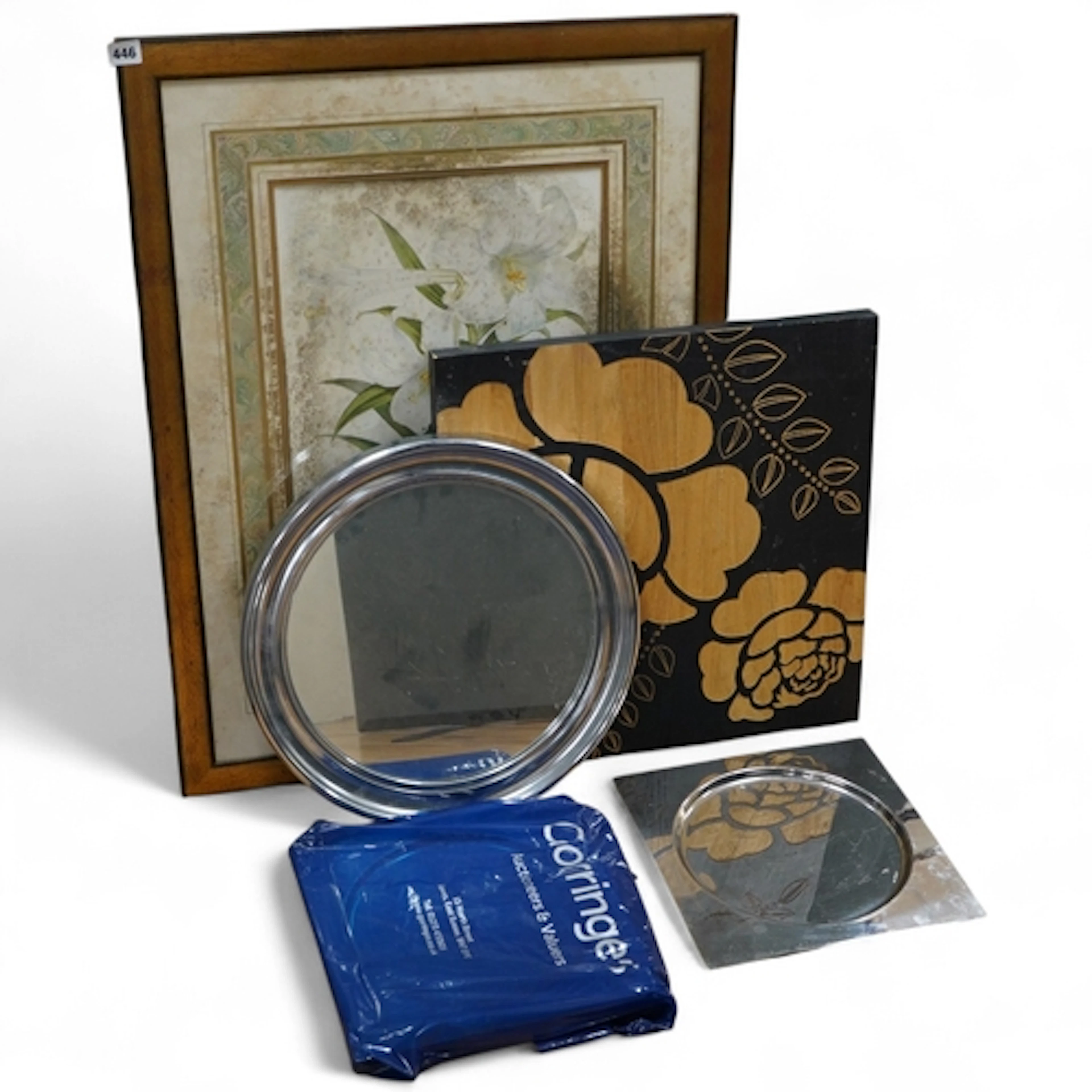 A framed botanical print, circular mirror, floral wood block...