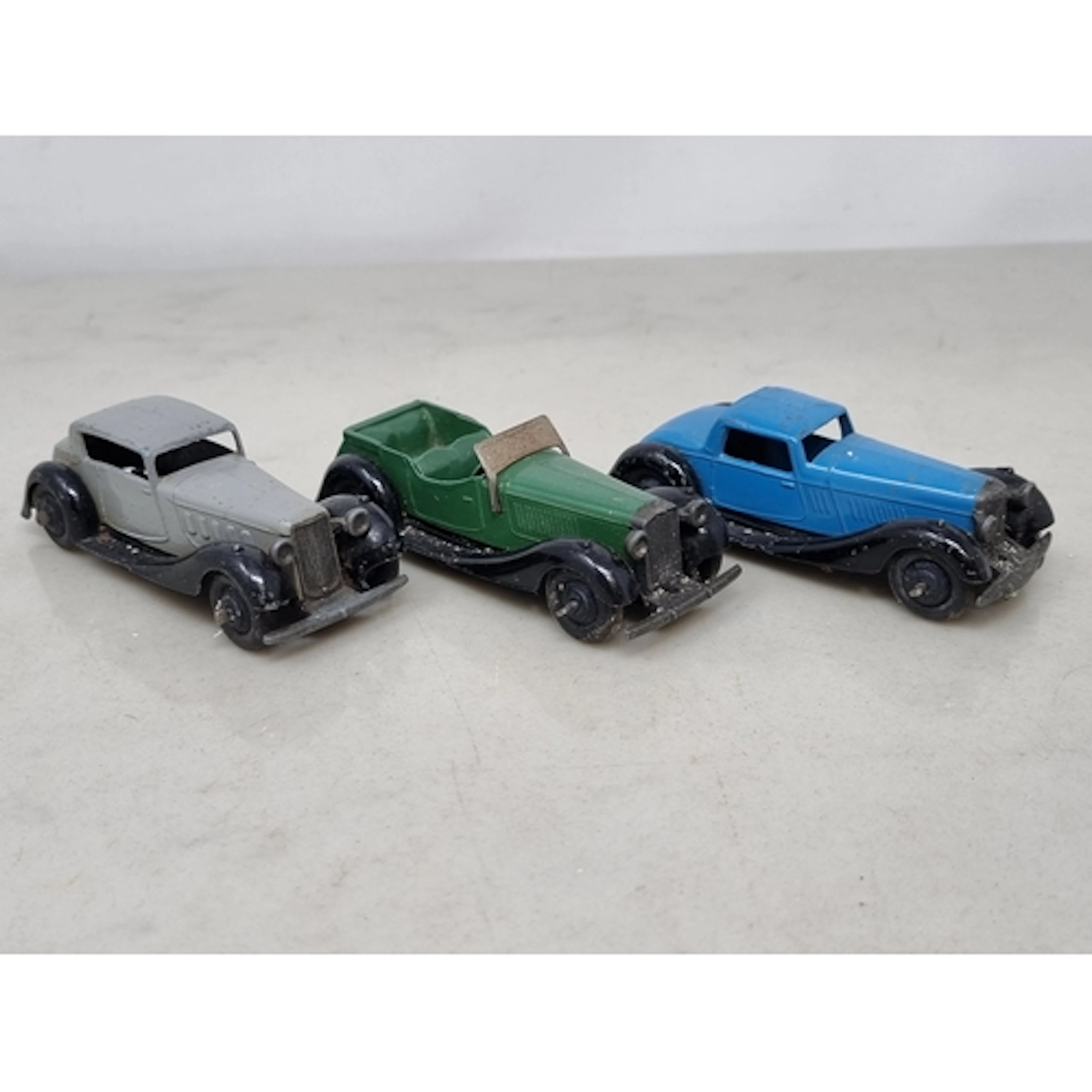 Three Dinky Toys comprising green Salmson four-seater, light...