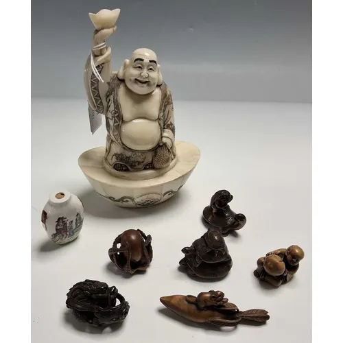 A GROUP OF NETSUKE, A SNUFF BOTTLE AND A BONE ORIENTAL FIGUR...