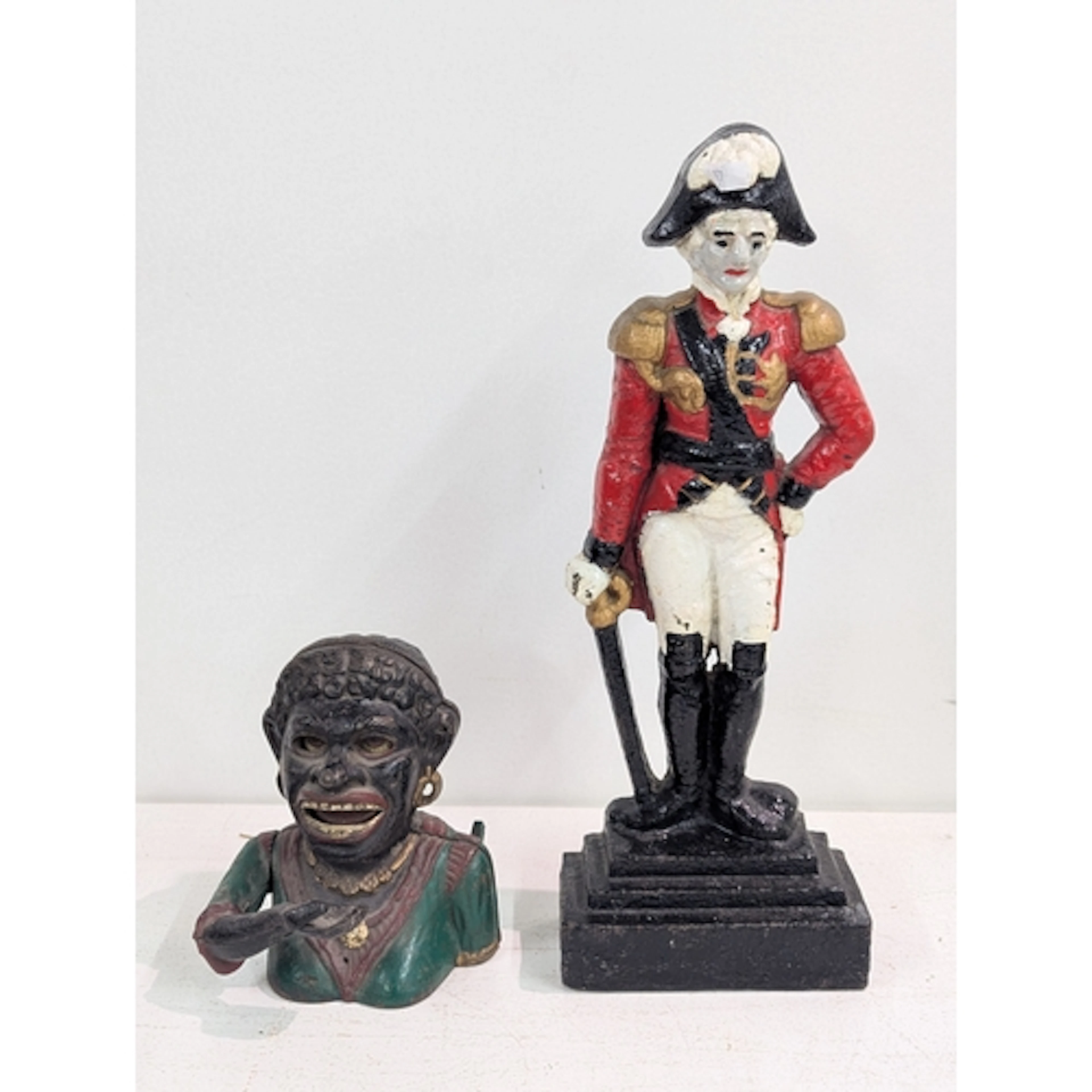 An early 20th century cast metal money box, together with a ...