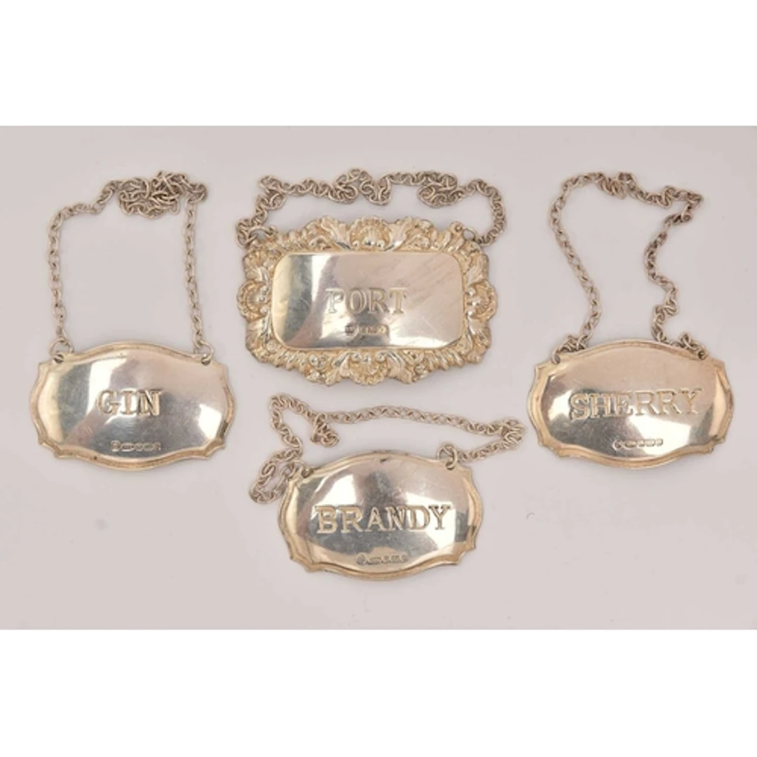 FOUR SILVER DECANTER LABELS, one for 'Gin, Brandy, Sherry' m...