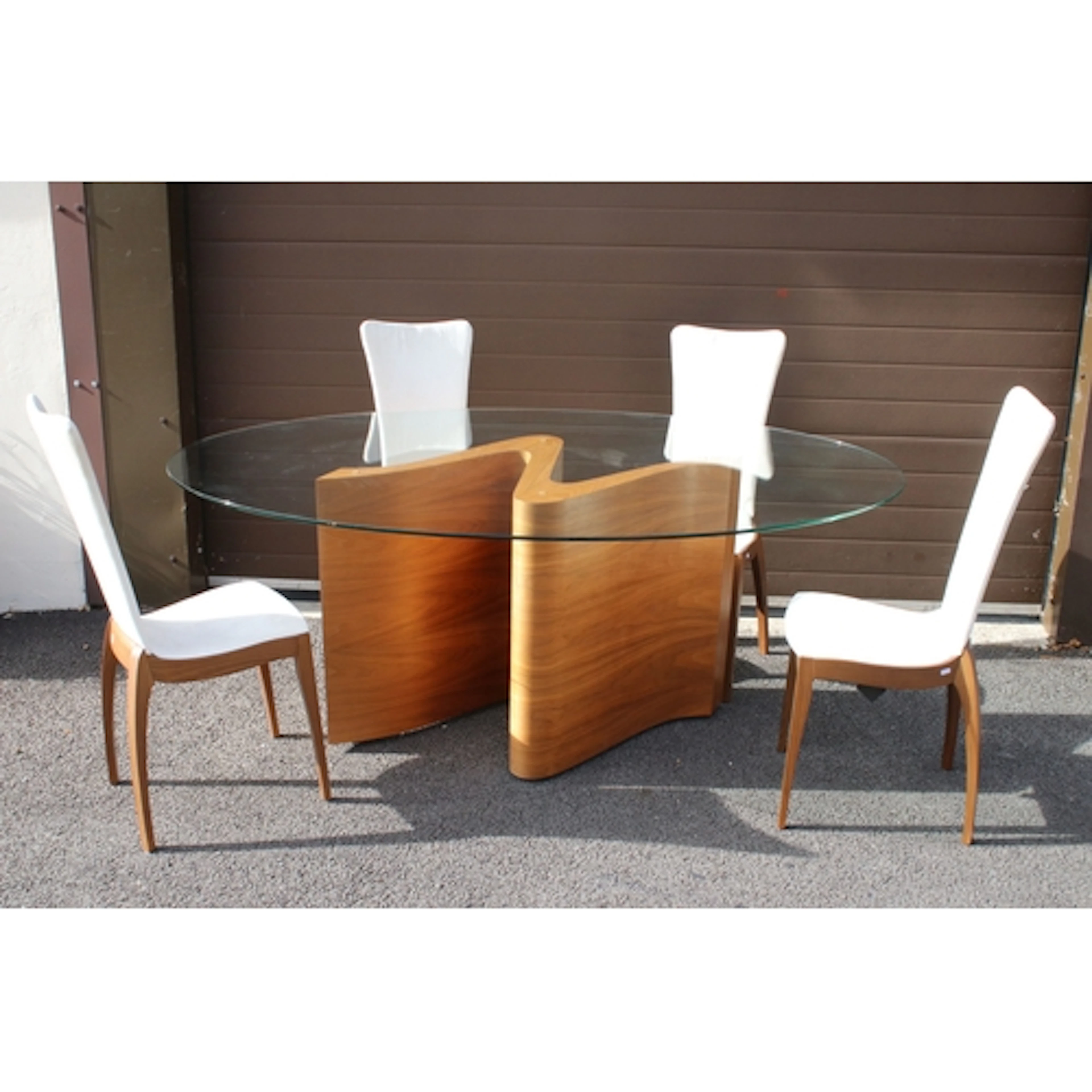 Tom Schneider 'Serpent' glass topped dining table, having ov...