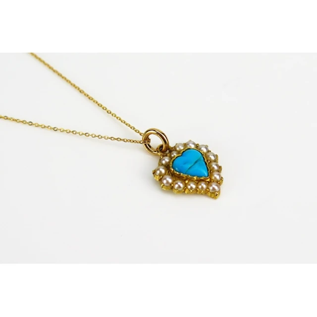 A turquoise and seed pearl heart shaped pendant in a preciou...