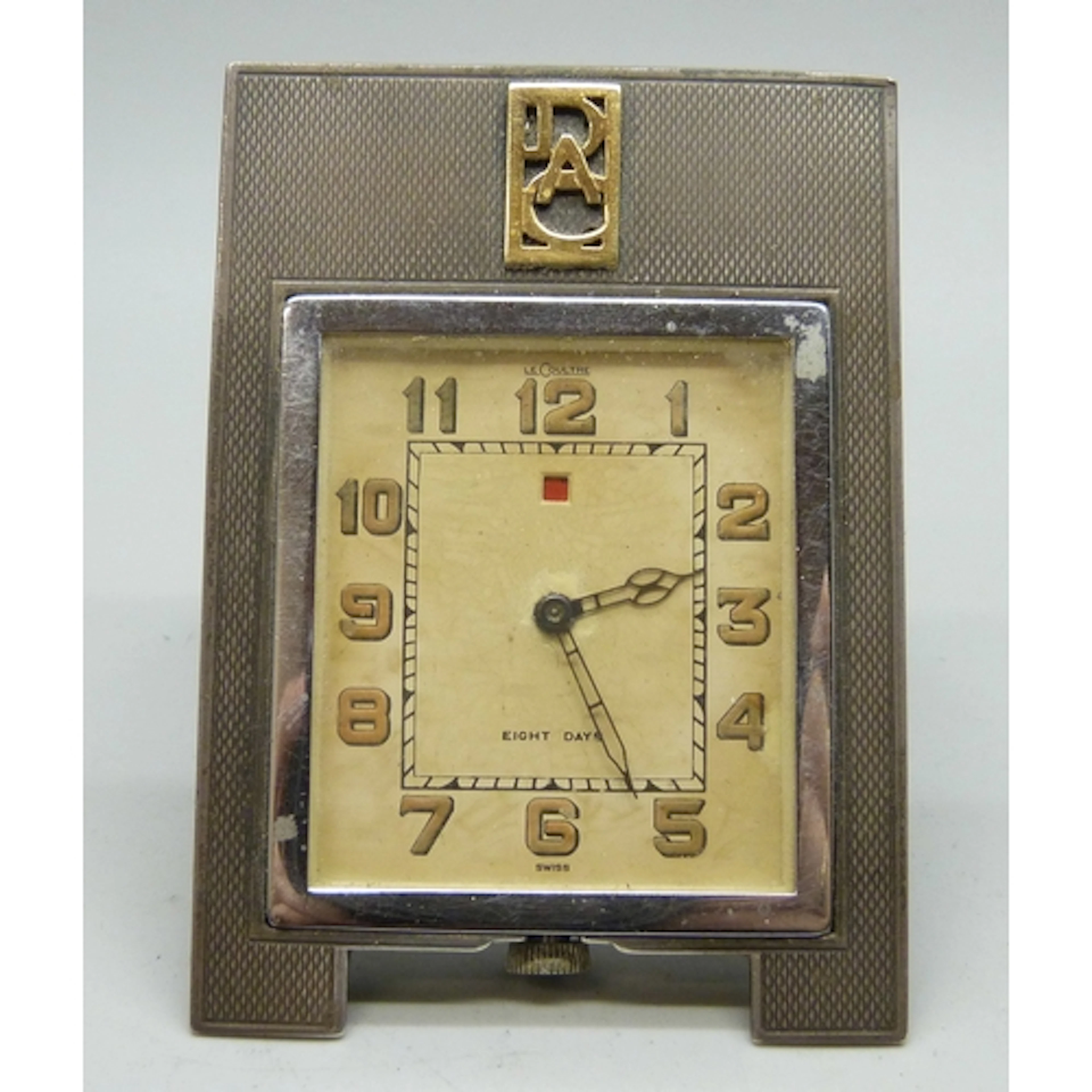 An Art Deco Le Coultre 8 day travel clock with silver frame,...