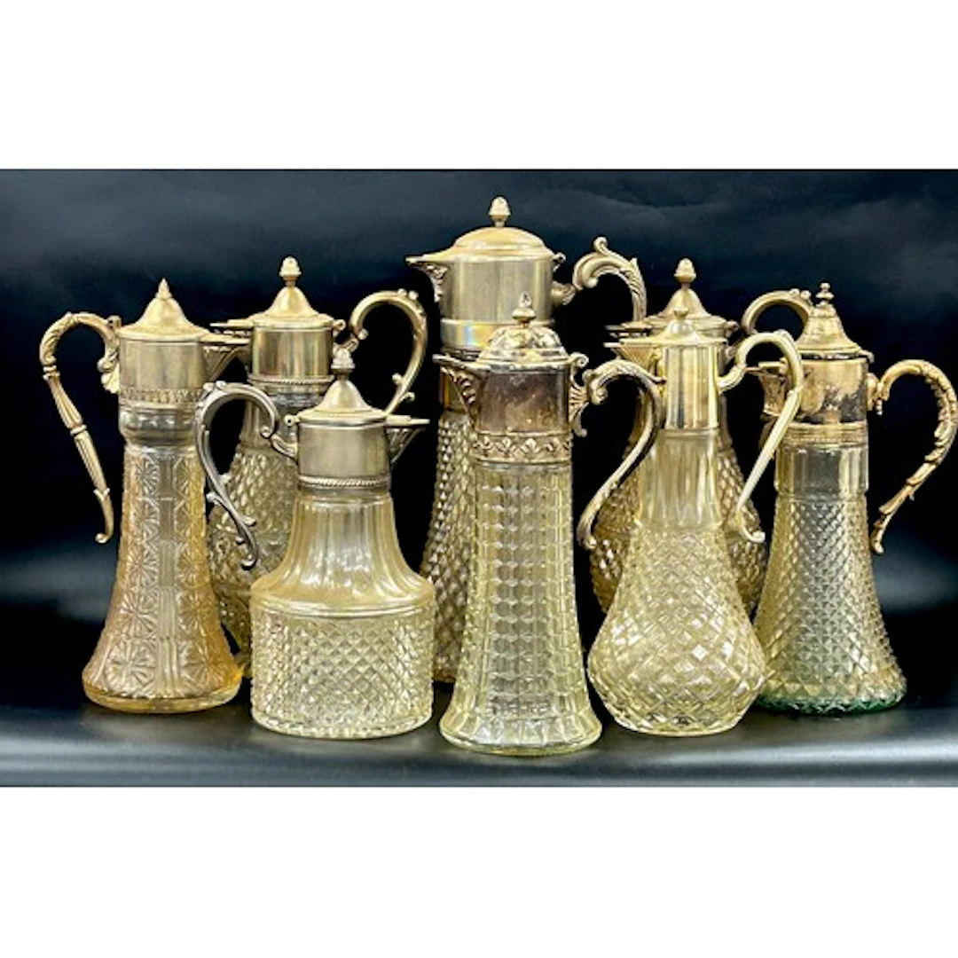 A large collection of Claret jugs