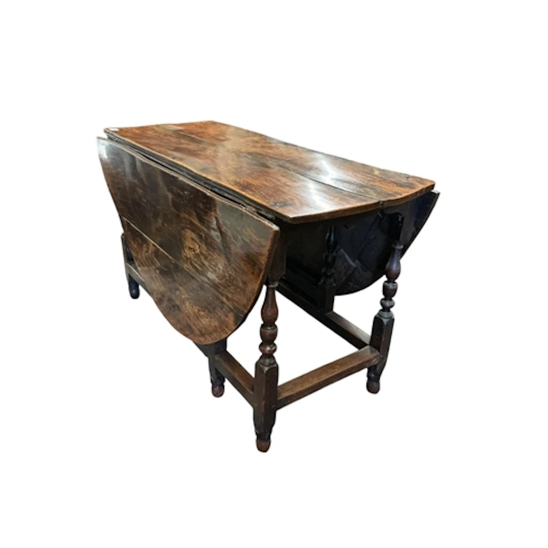 An 18th century oak and elm oval gateleg table, fitted drawe...