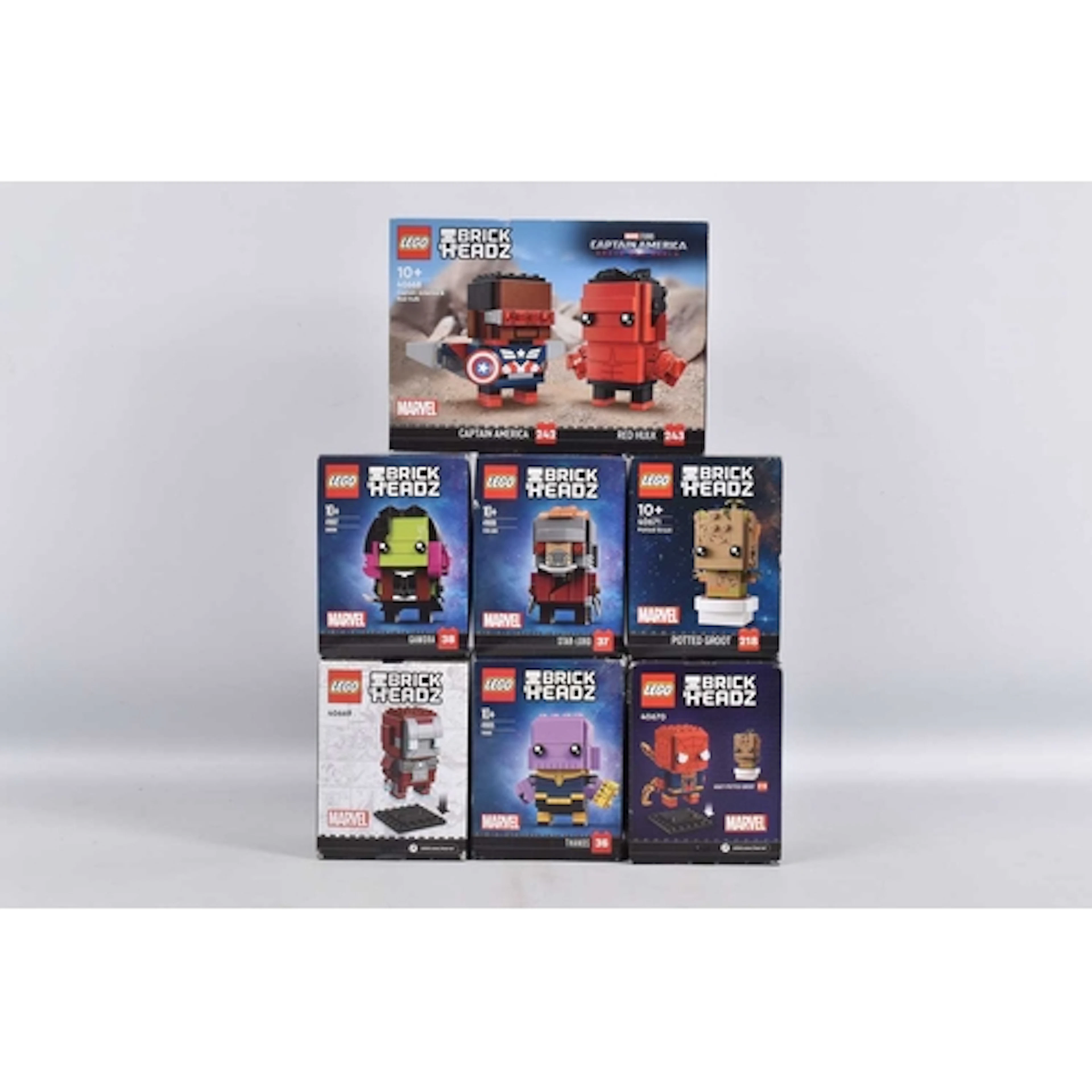 SEVEN BOXED AND SEALED LEGO MARVEL BRICKHEADZ, to include Ca...