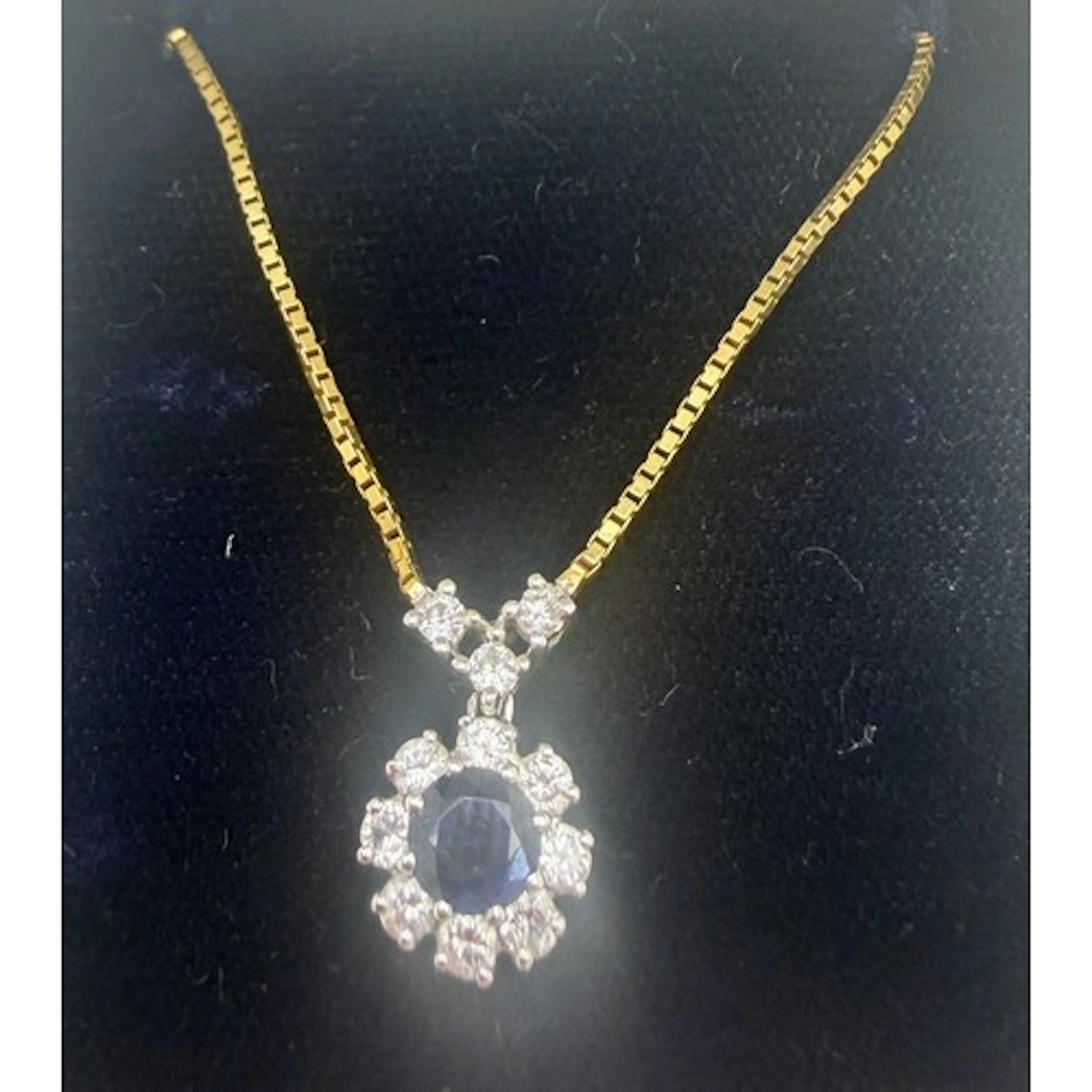 An 18 carat gold pendant set with diamonds and central sapph...