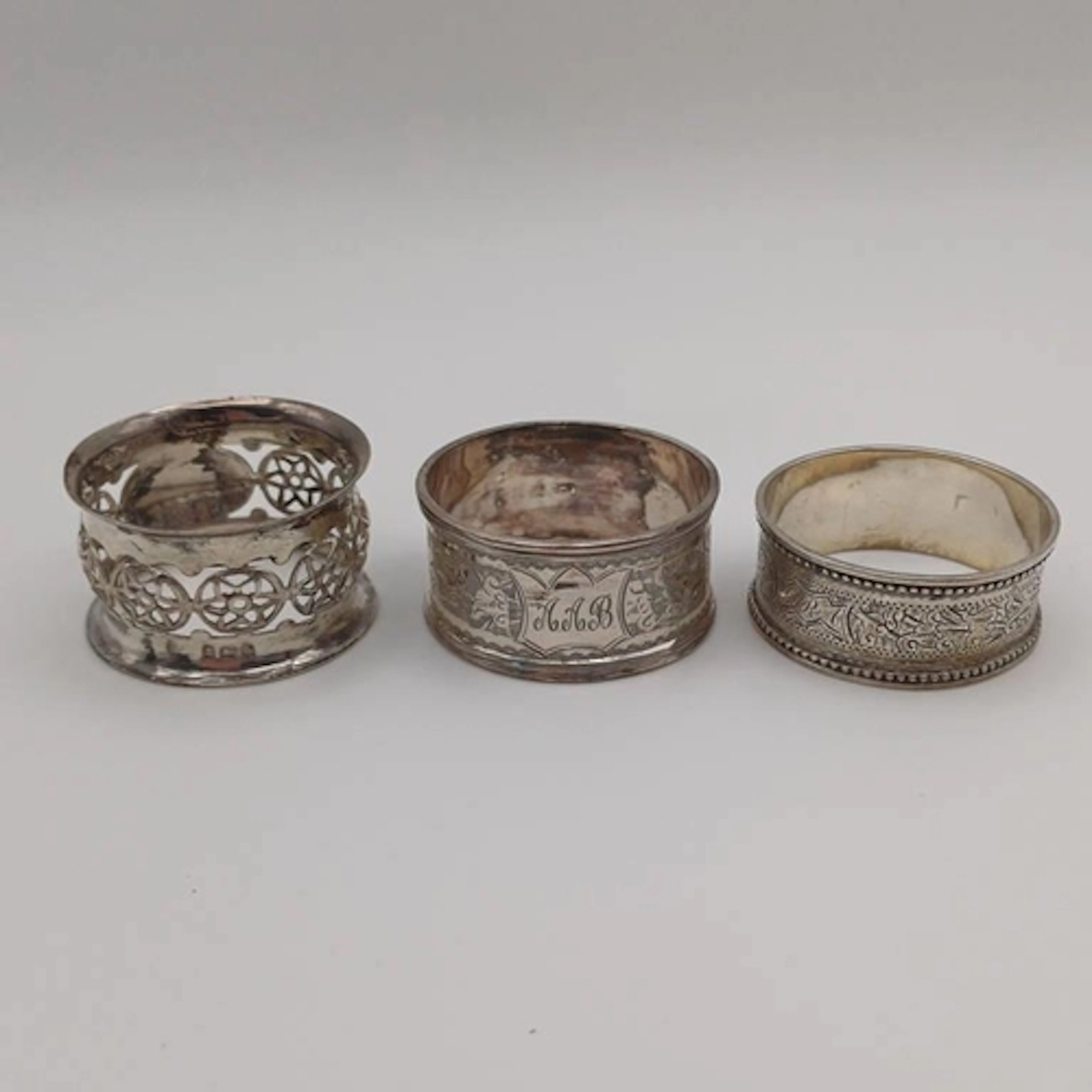 3 SILVER NAPKIN RINGS. 53G