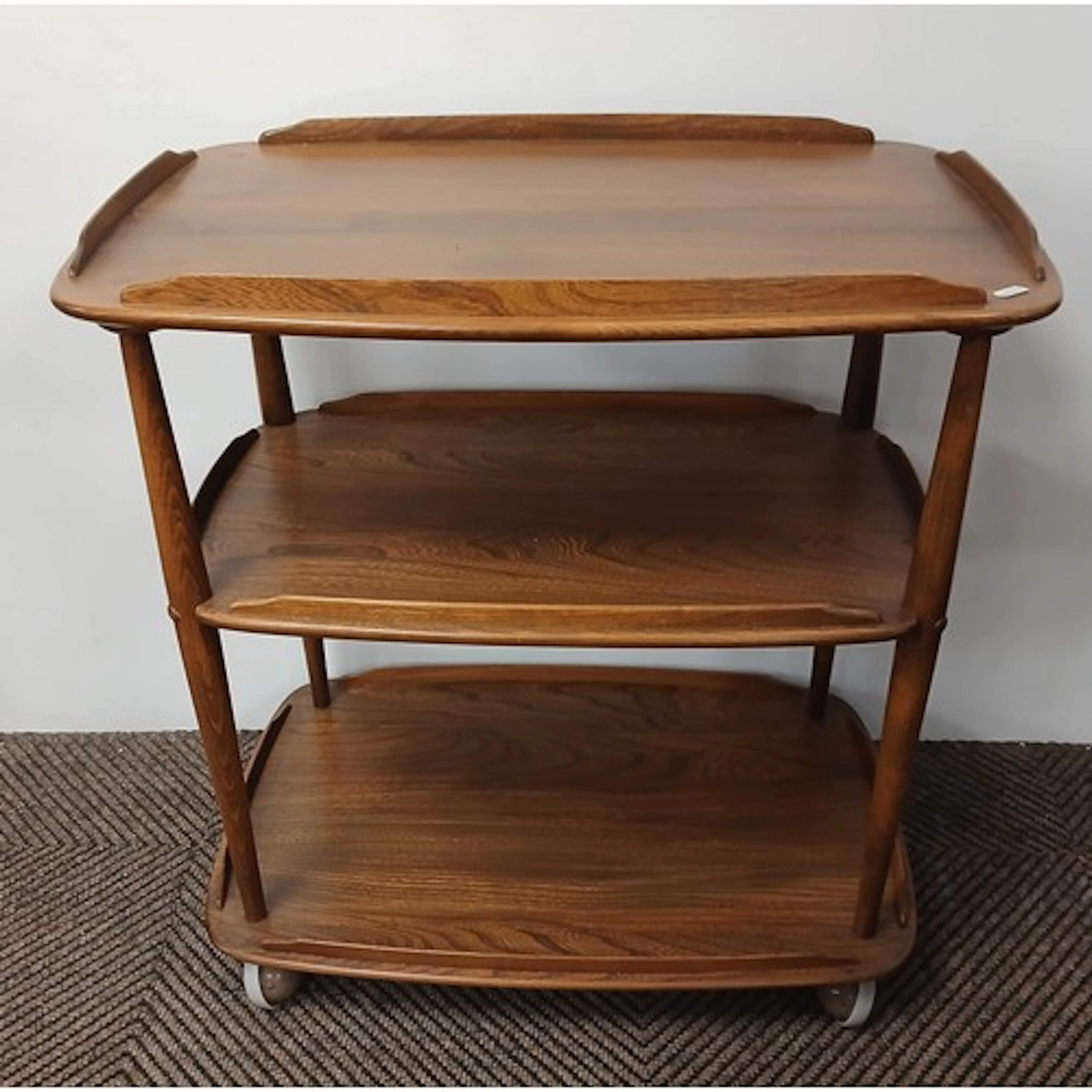 Ercol light oak three-tier trolley.