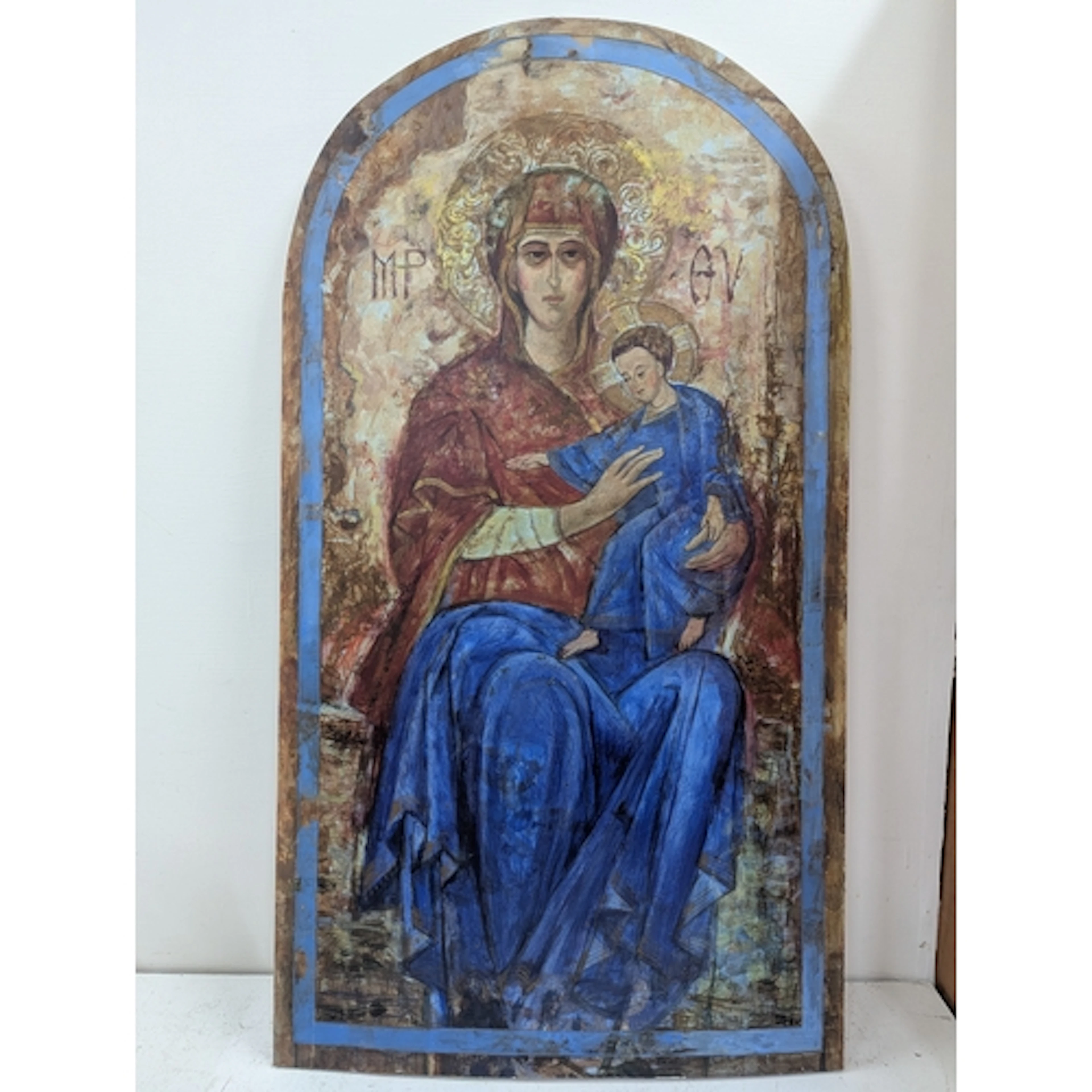 A religious painting on wooden plaque depicting mother and c...
