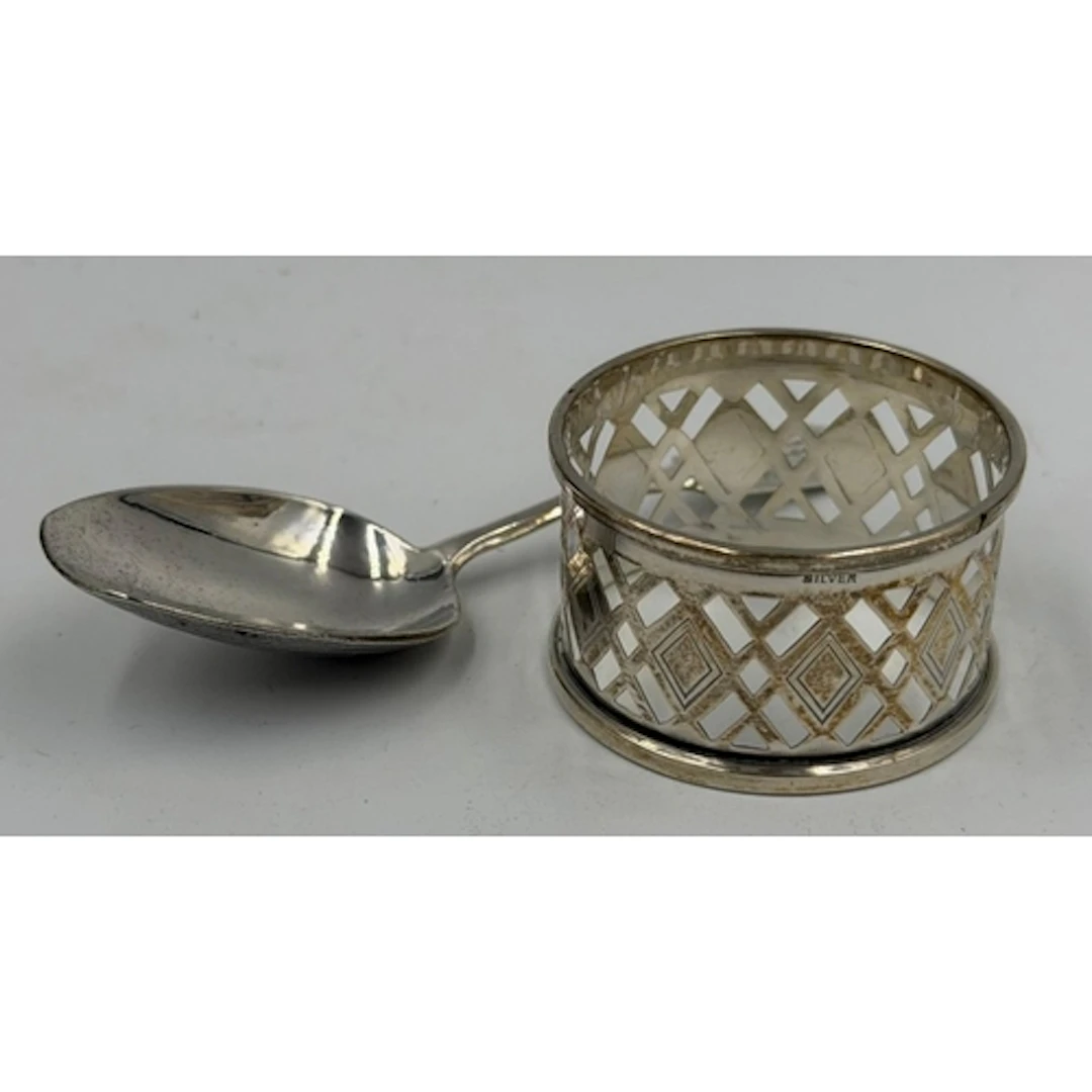 A Russian silver caddy spoon and a silver napkin ring with a...