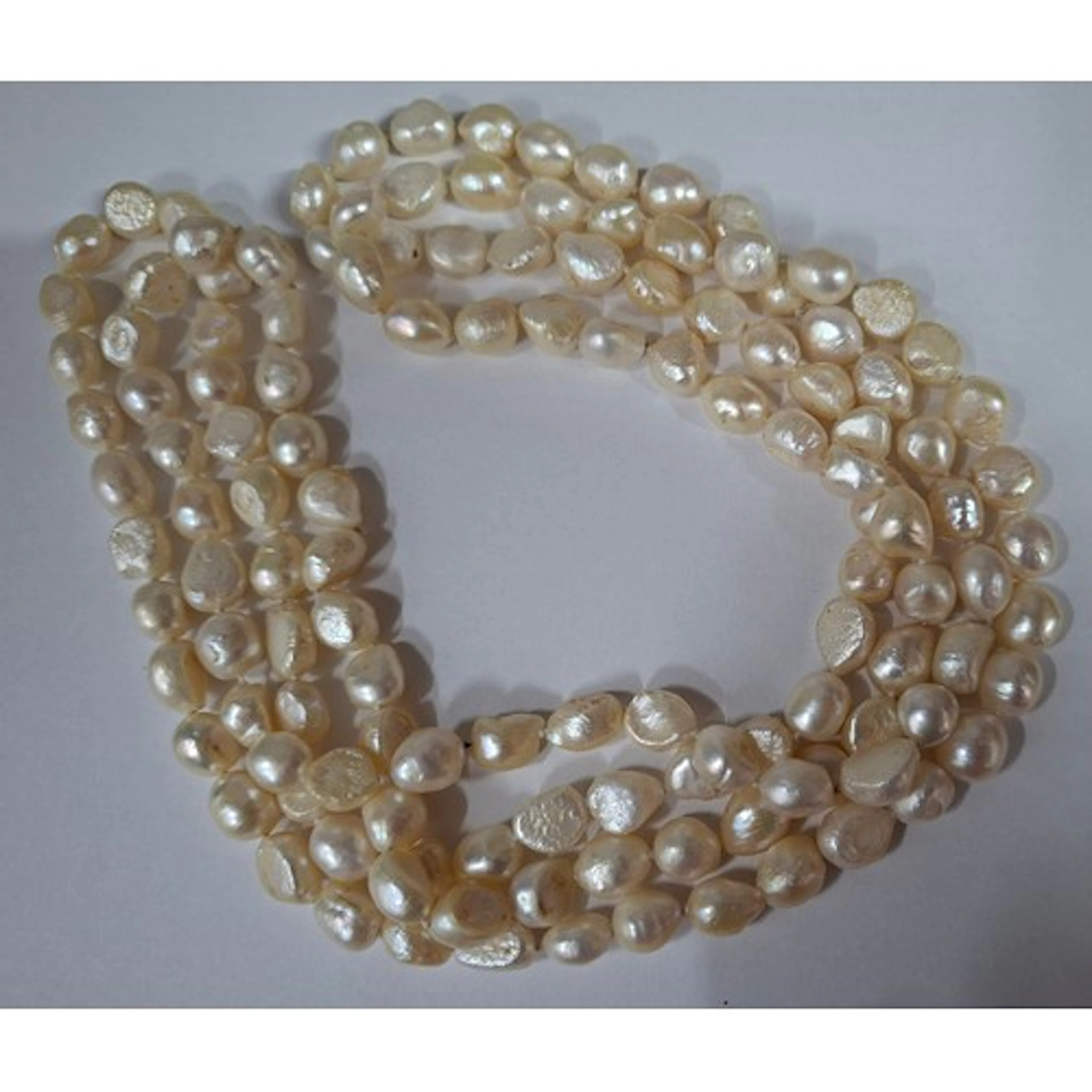 A long strand necklace of baroque pearls having a double kno...