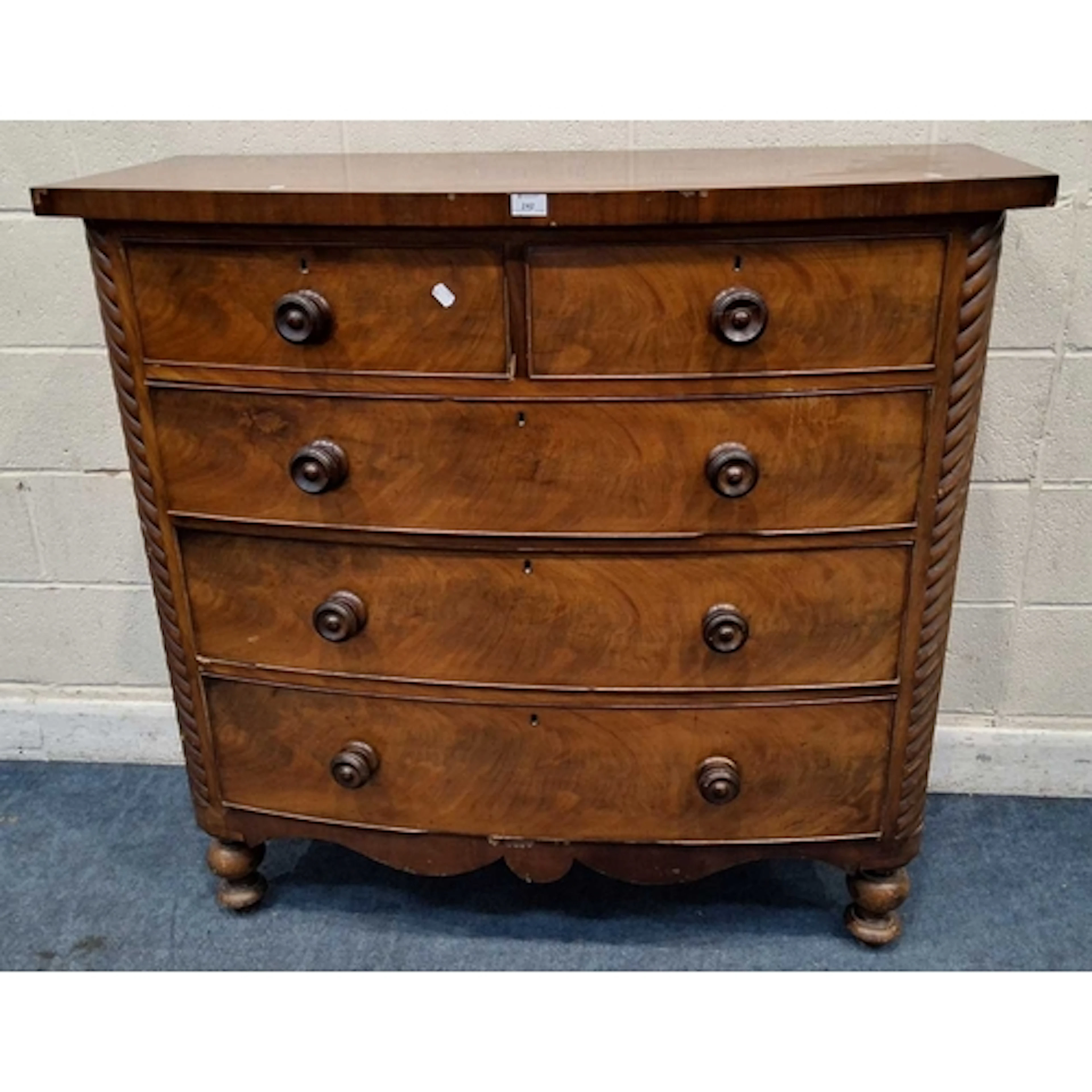 A 19TH CENTURY MAHOGANY BOW FRONT CHEST OF TWO SHORT OVER TH...
